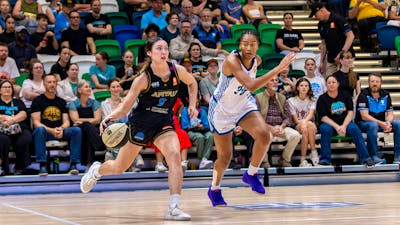 UC Capitals player driving to the basket to complete a layup.