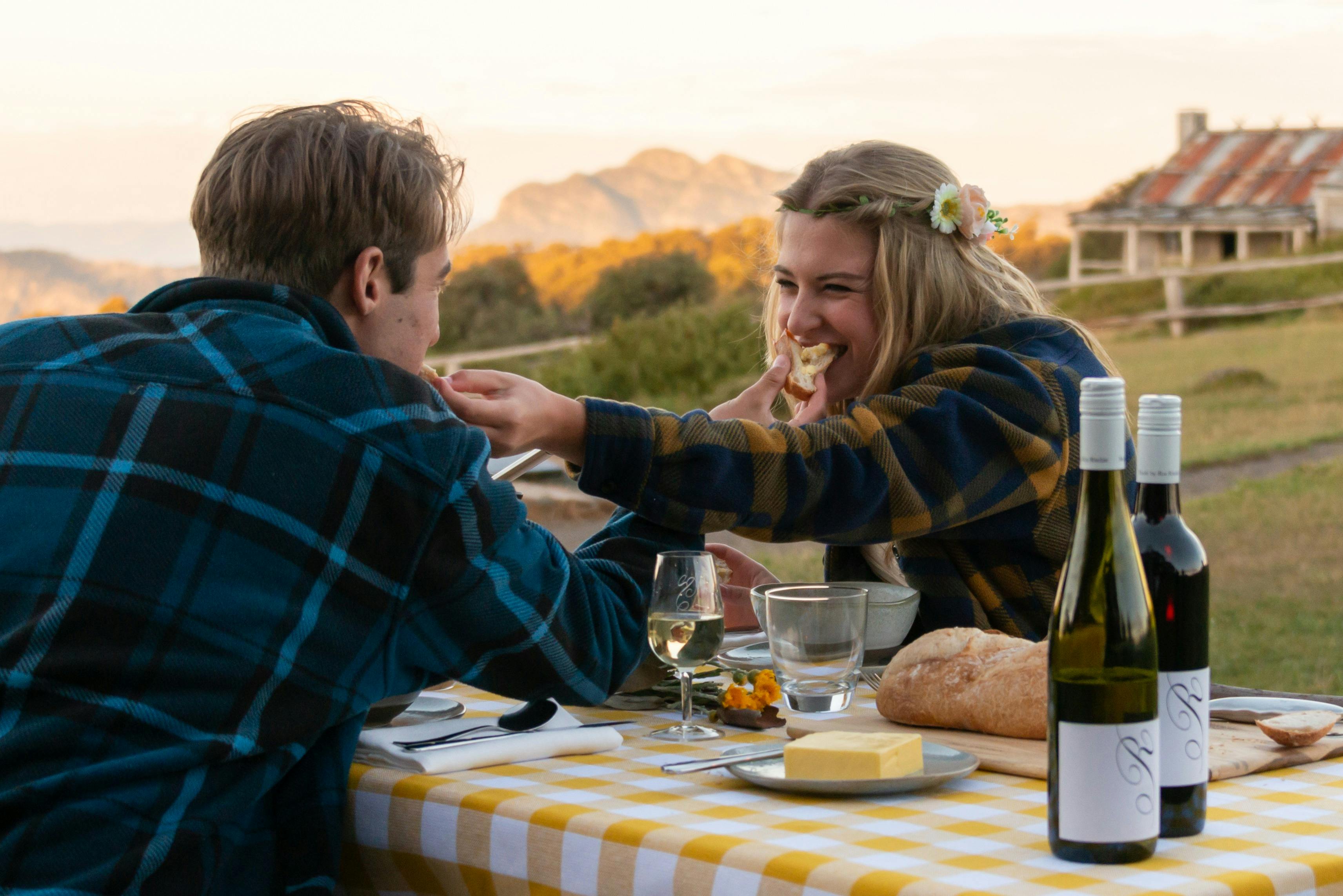 Just married couple enjoying a sumptuous sunset dinner at Craig's Hut.