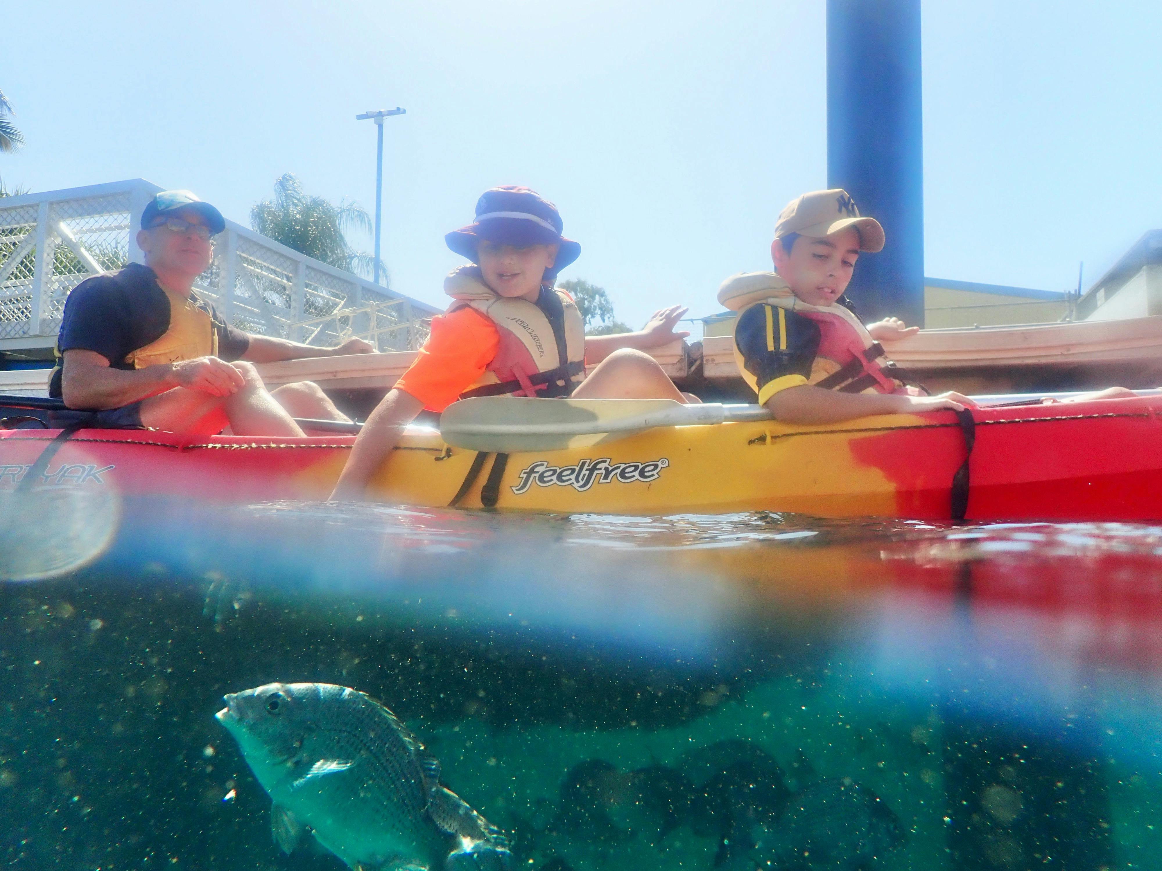 KidFish feeding on the family kayak tour with 1770 Liquid Adventuress on a kayak feeding the fish