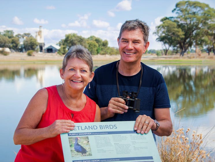 couple standing wit hthe bird life sign at the Corowa Wetlands