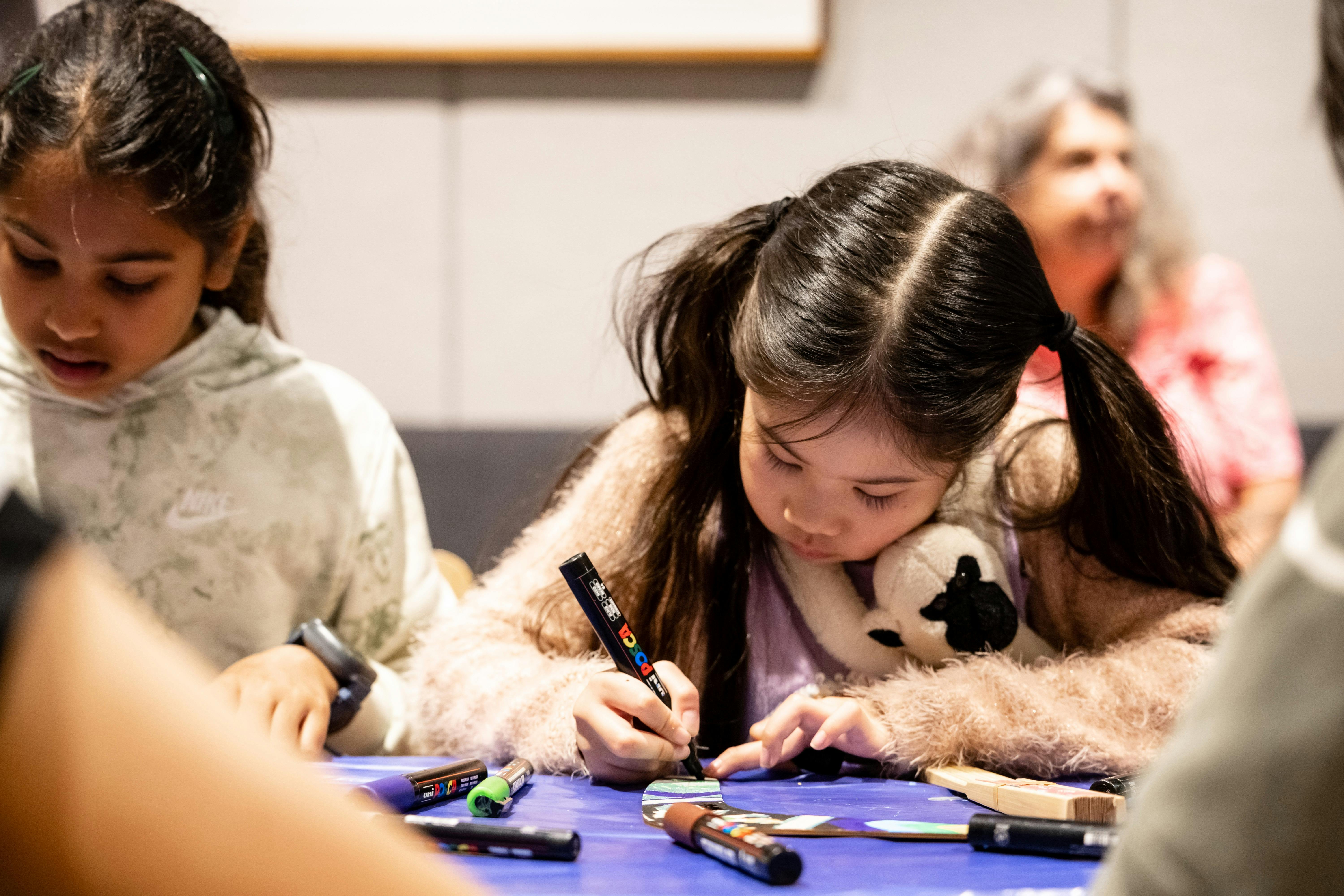 A young girl makes art at Parliament of NSW