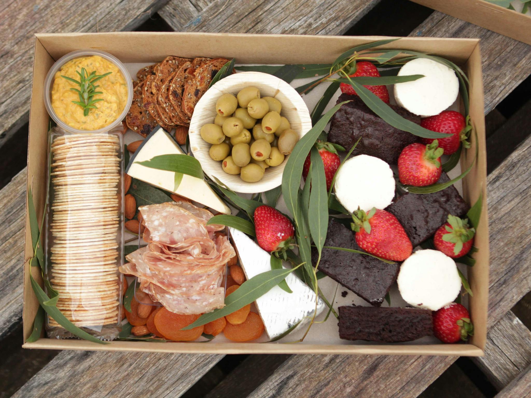 A platter box with sweet and savoury foods