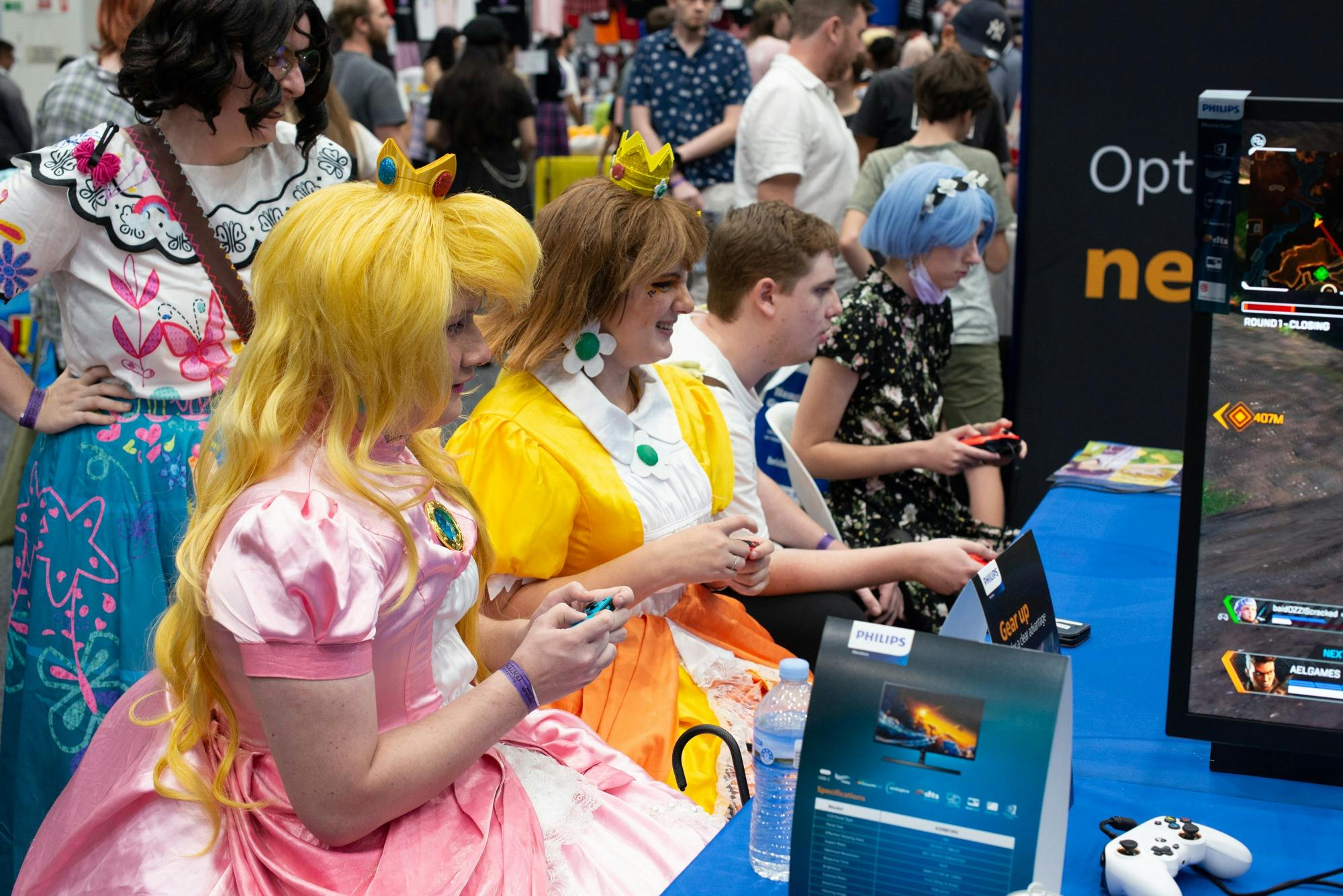 A group of people in cosplay engaged in playing computer games
