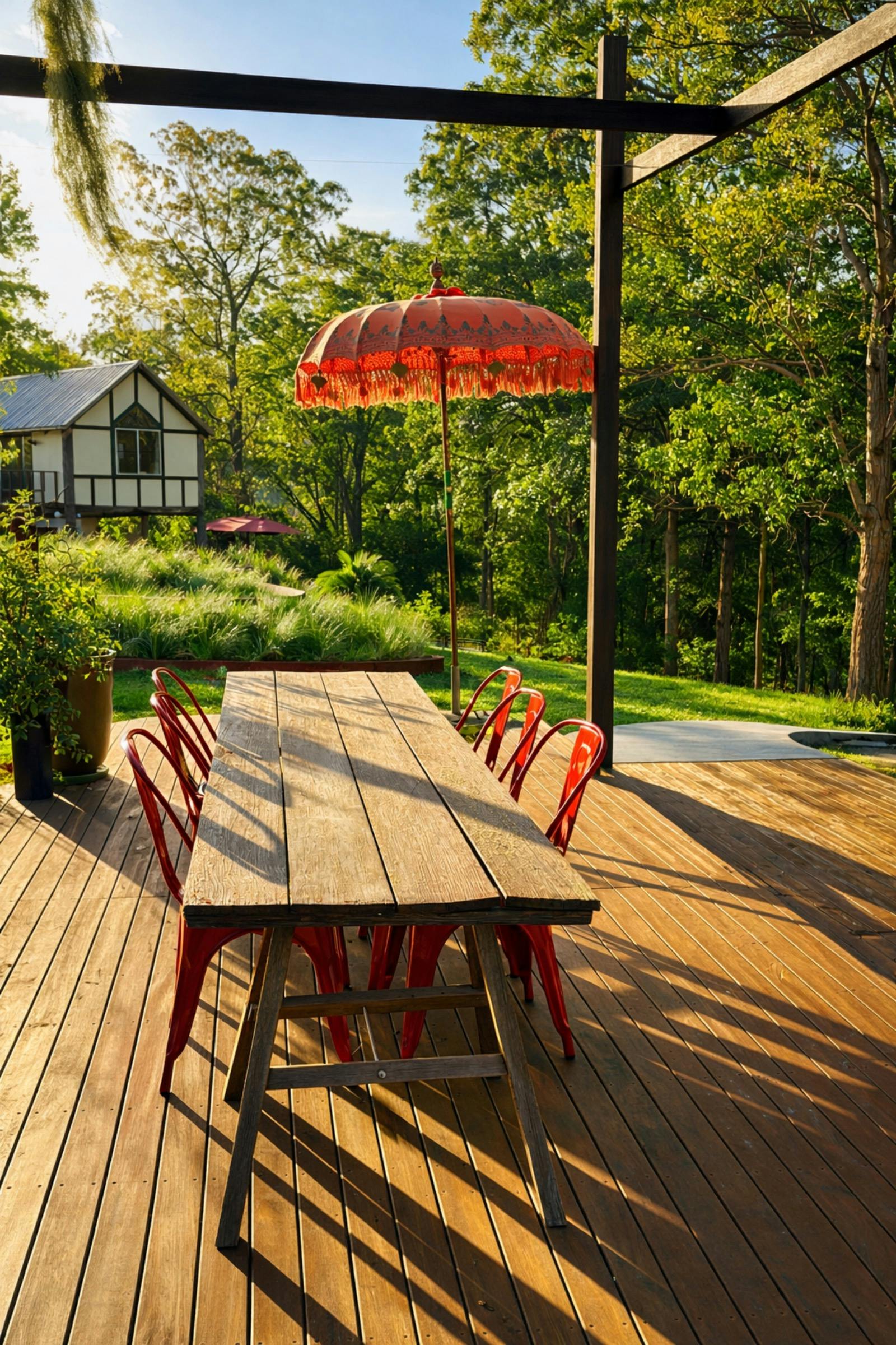 Red chair around a lovely old wood timber table ona deck
