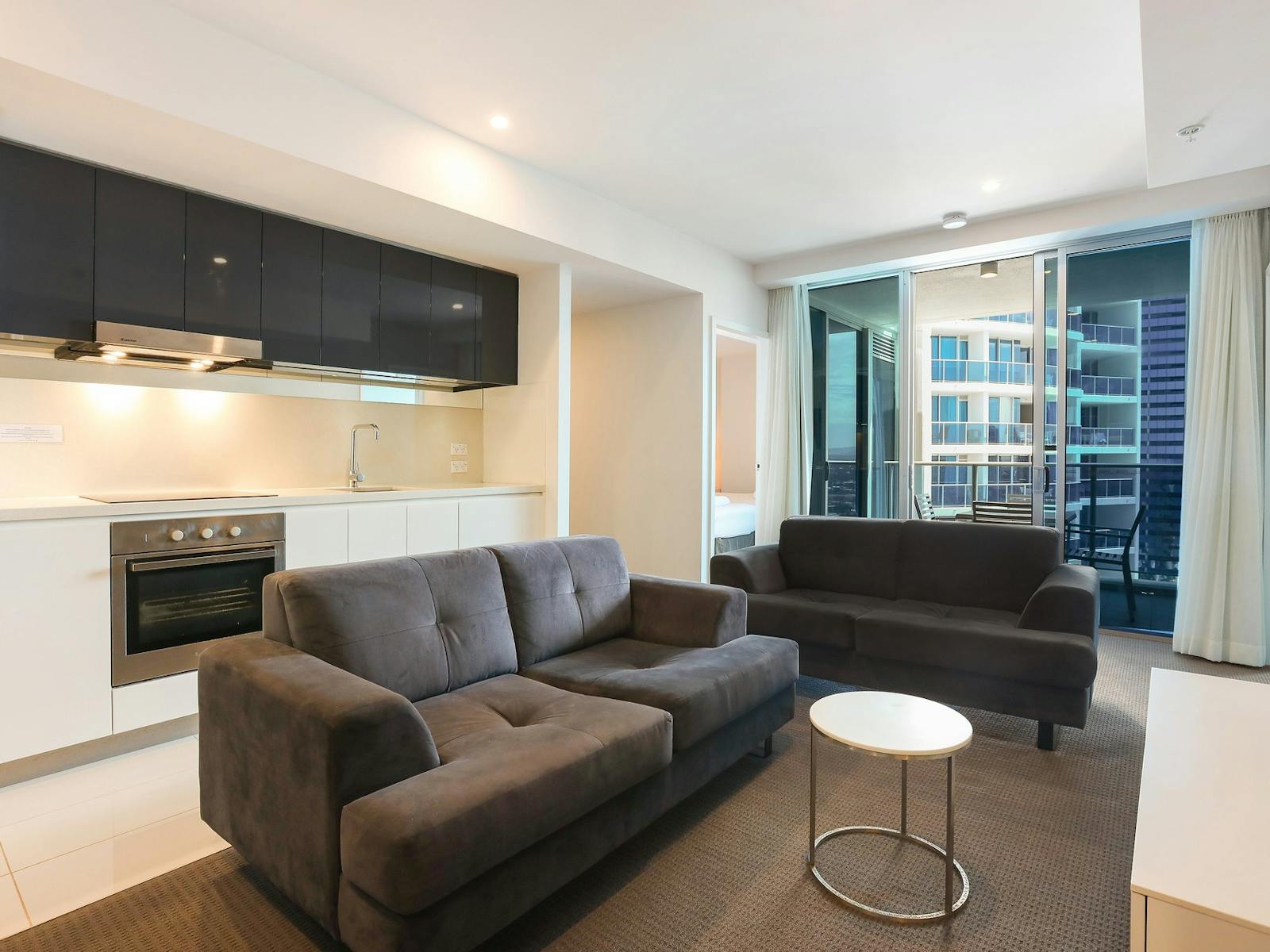 Open plan living - lounge room and kitchen behind - Hilton Residences Surfers Paradise Gold Coast Open plan living - lounge room and kitchen behind - Hilton Residences Surfers Paradise Gold Coast