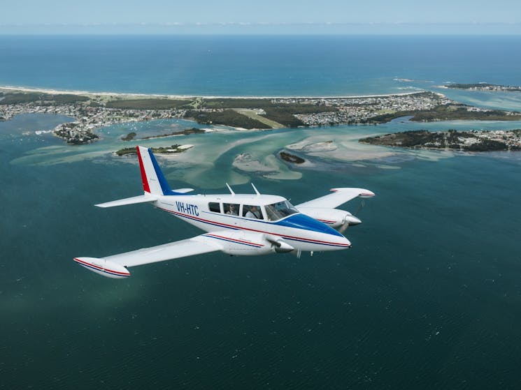 A pilot taking passengers for a joy flight over Lake Macquarie