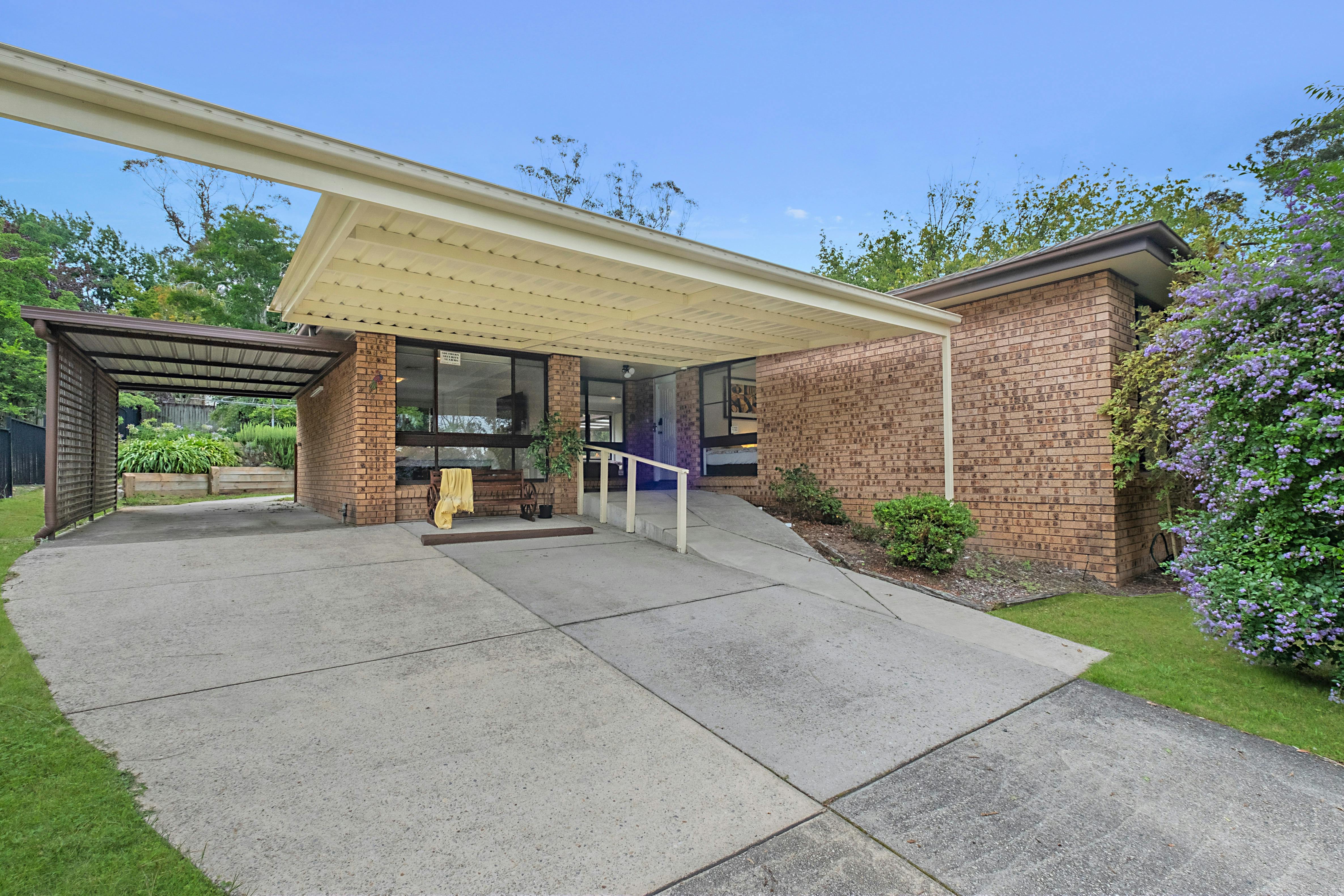 Covered carport areas for dry entrance and exits for two cars. Room for a third car on the driveway.