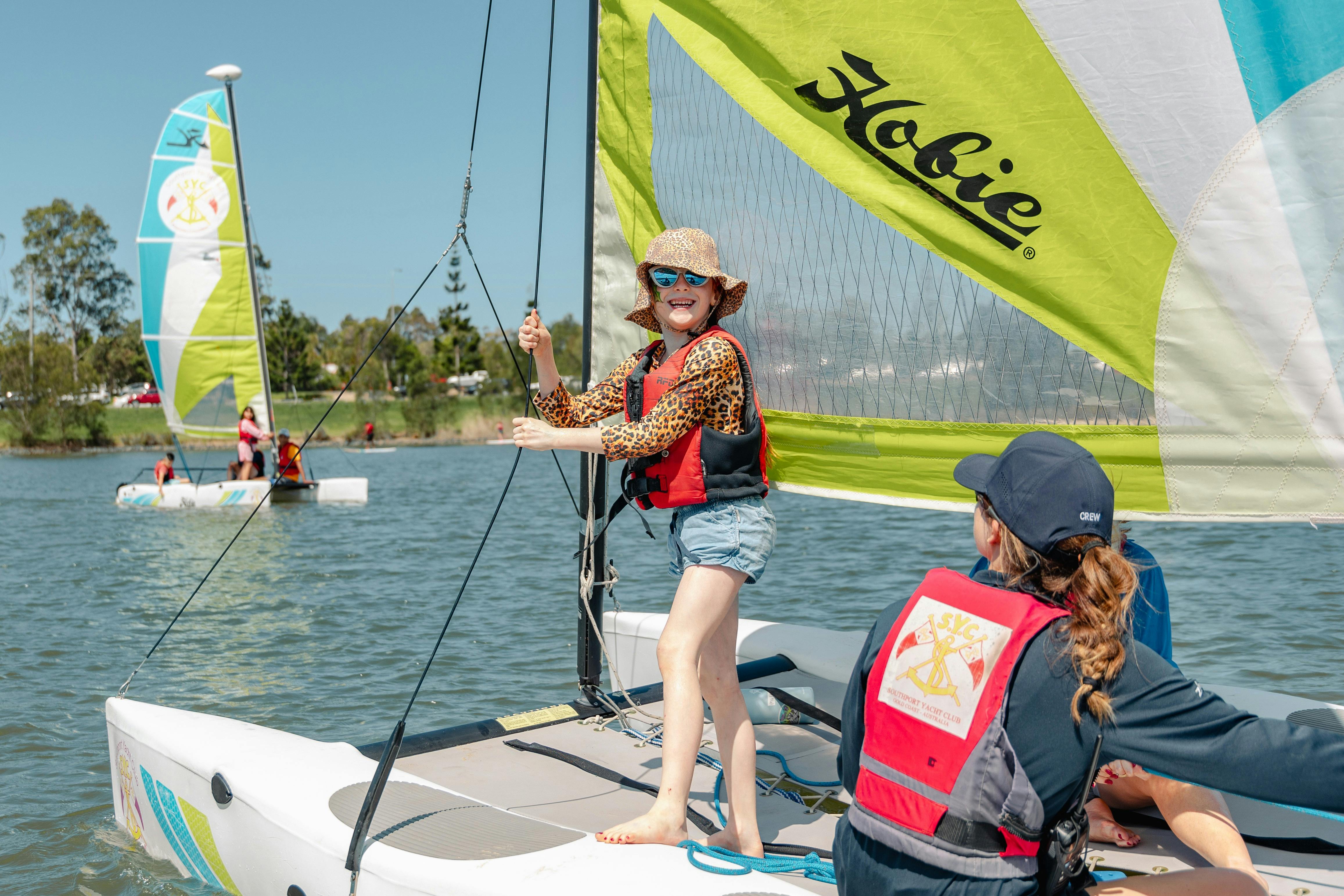 Smiling child on sail boat during school holidays