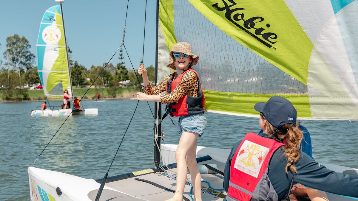 Smiling child on sail boat during school holidays