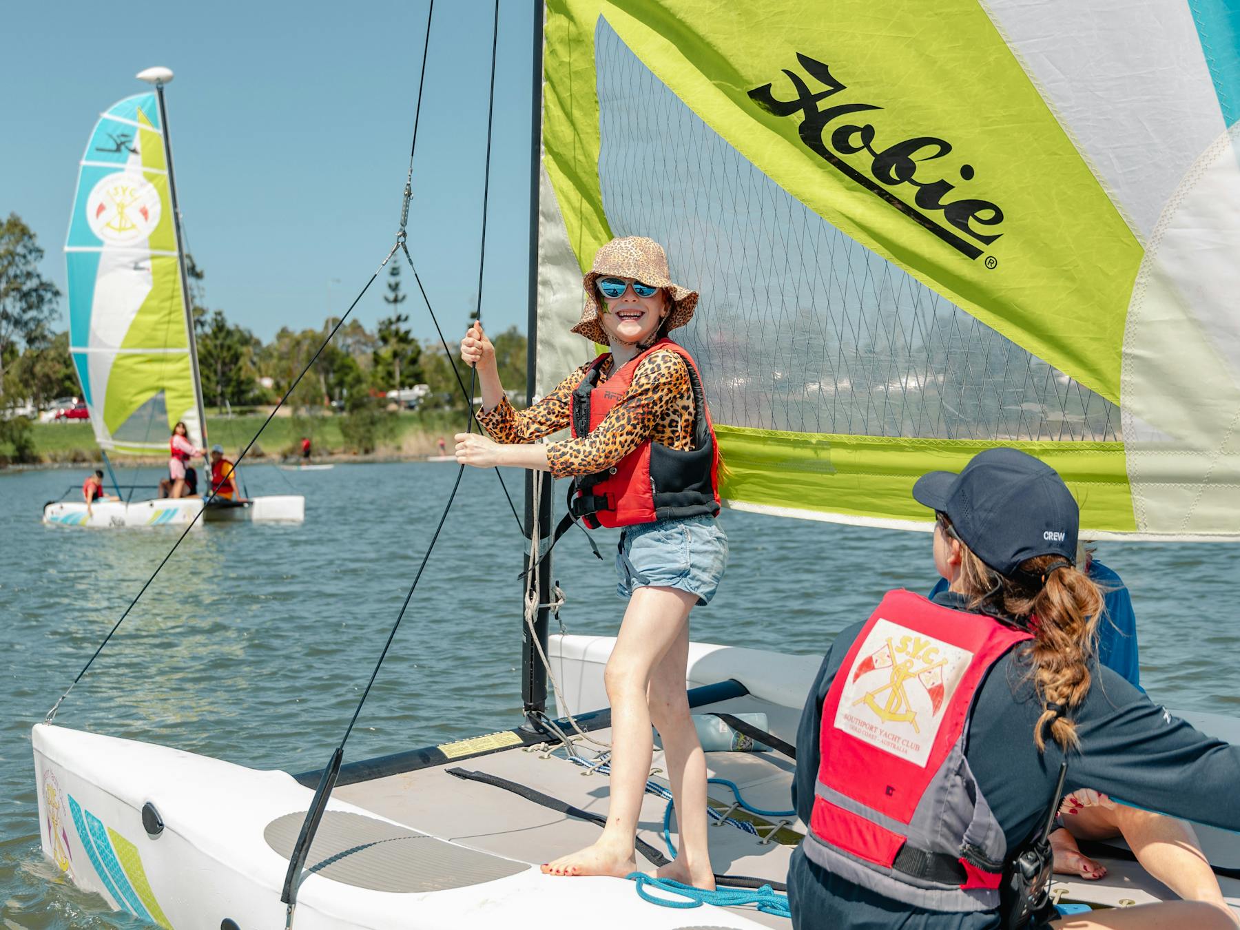 Smiling child on sail boat during school holidays