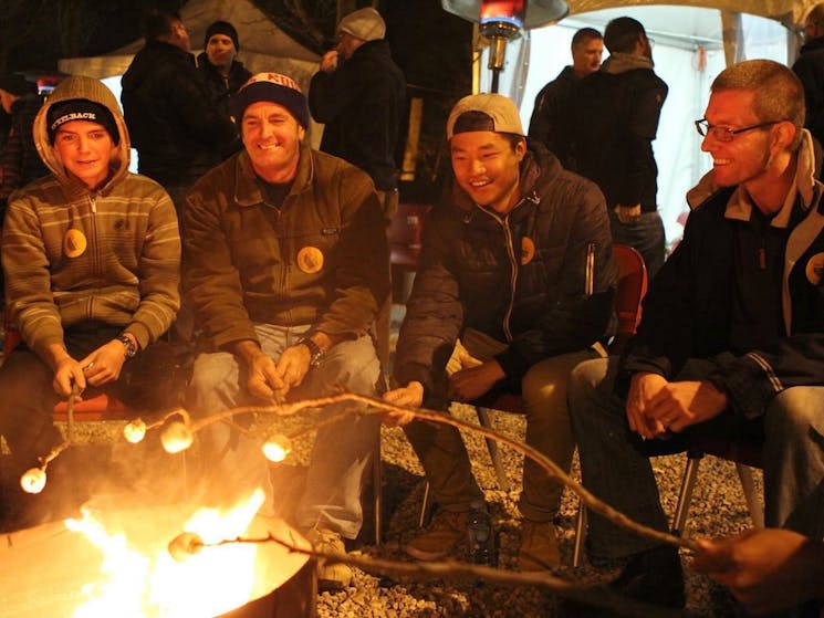 Roasting marshmallows around a campfire