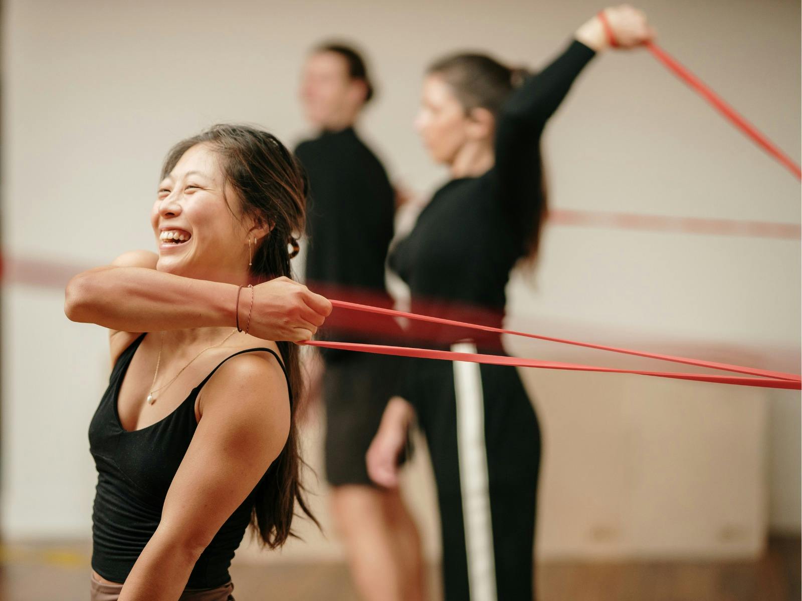 Awoman stretching a resistance band