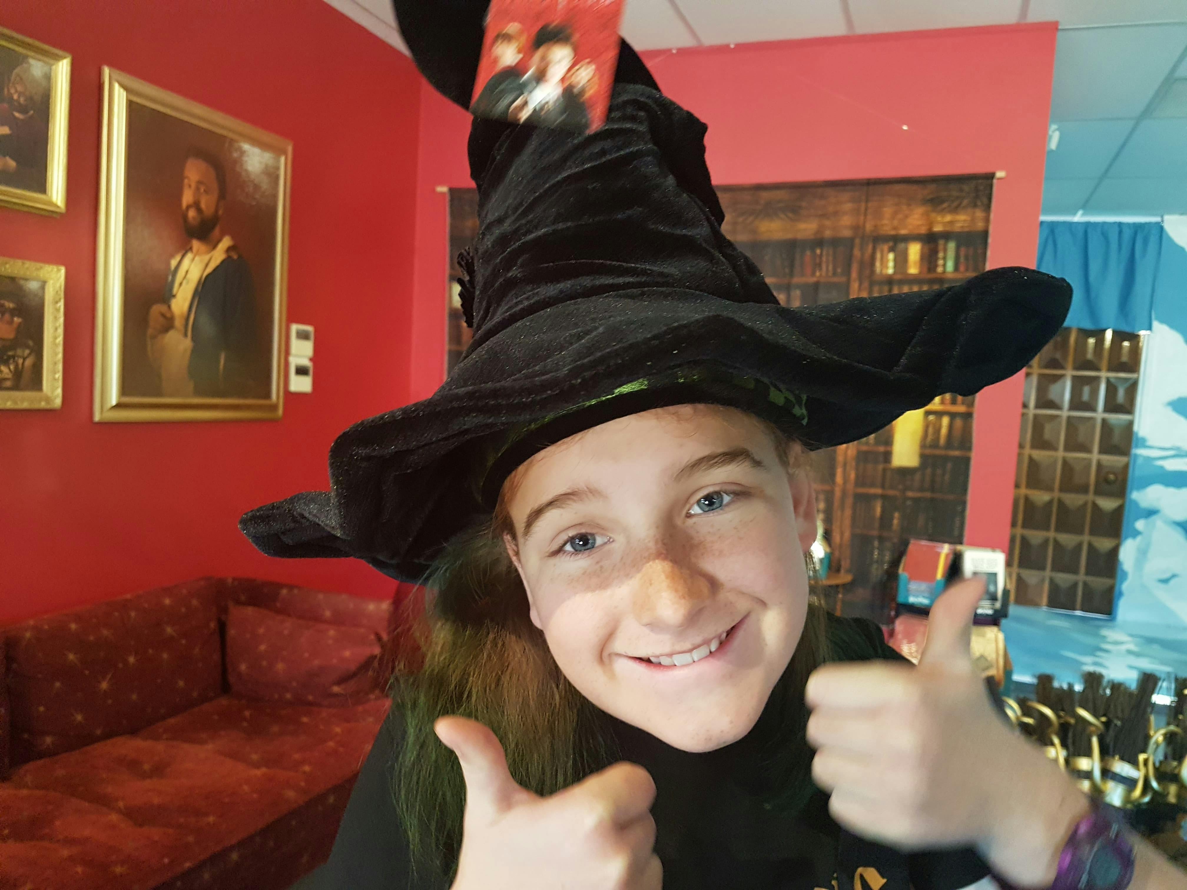 Young girl wearing a witch's hat