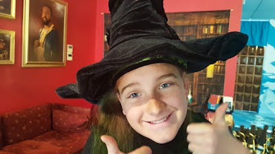 Young girl wearing a witch's hat