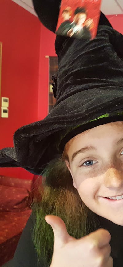 Young girl wearing a witch's hat