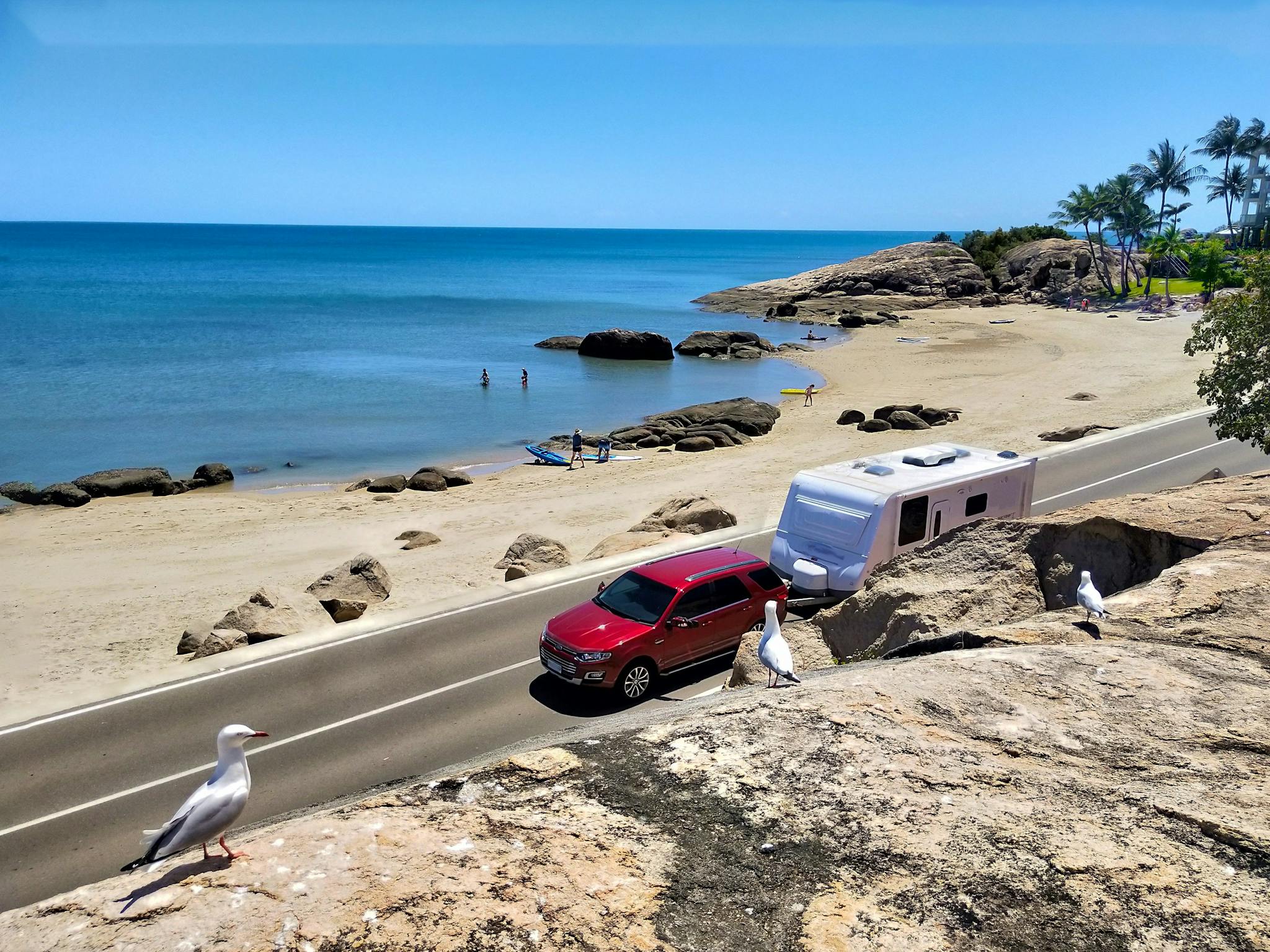 caravan being towed near beachside road