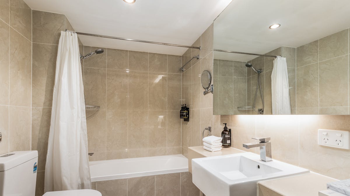 Bathroom - Deluxe Queen + Single with Shower over Bath