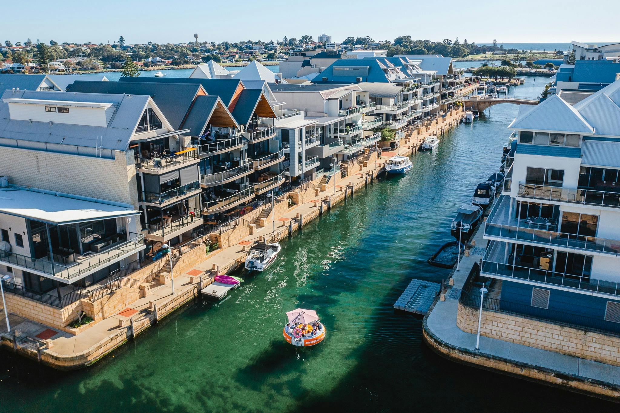 A drone shot of an eco bbq boat in Venetian Canals of Mandurah