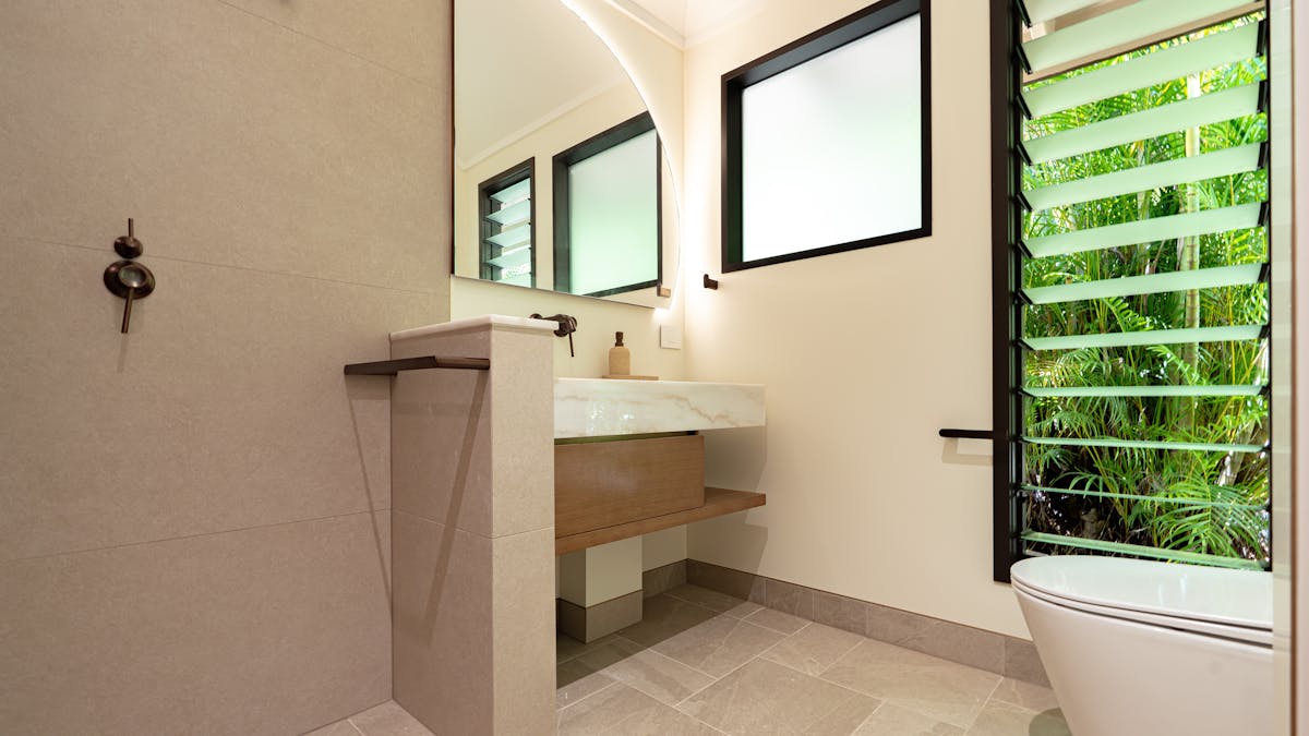 Ensuite with marble bench tops, timber vanitiy and large shower