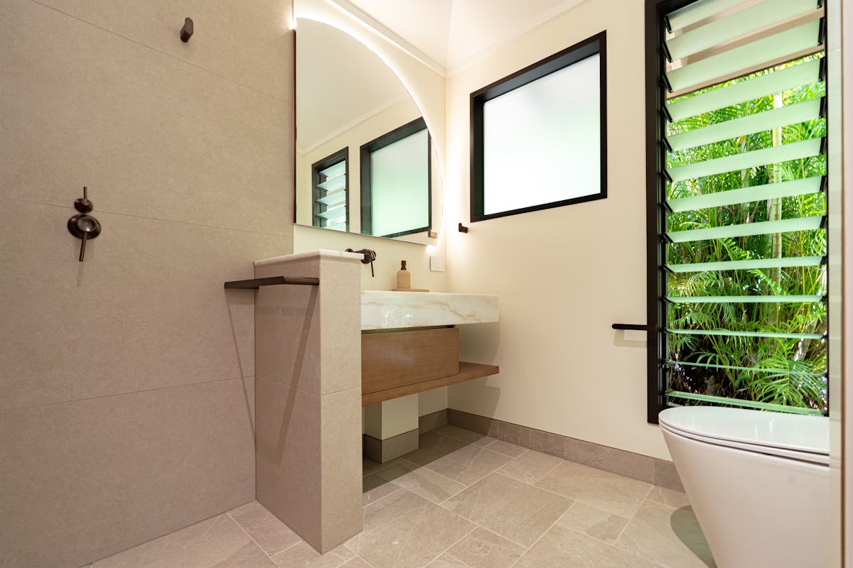 Ensuite with marble bench tops, timber vanitiy and large shower