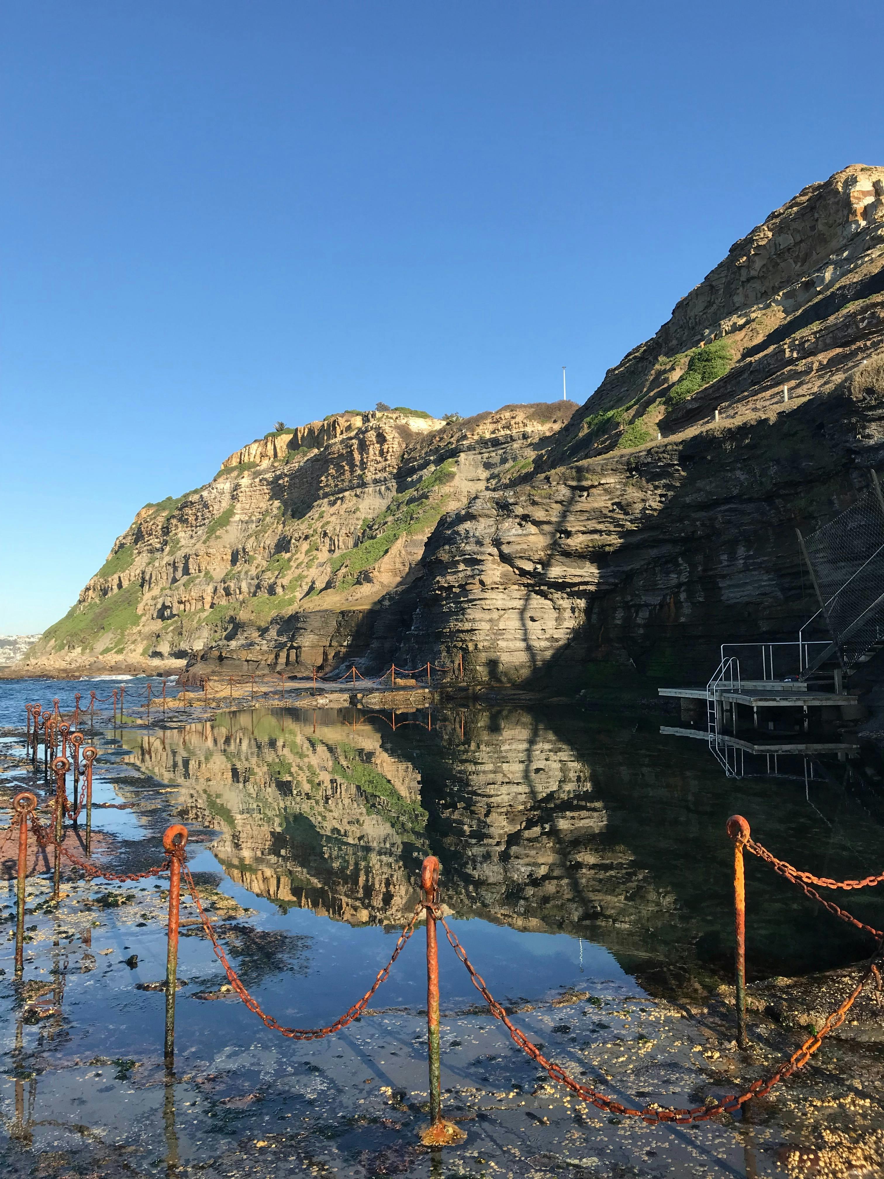 Reflections of the adjacent cliffs on the water surface at the Bogey Hole