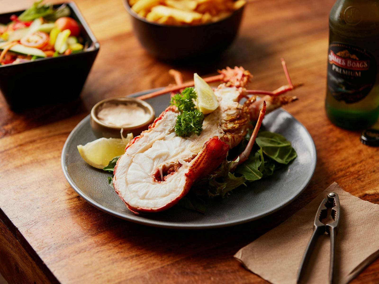 A plate with half a Tasmanian Southern Rock Lobster (crayfish), chips and salad