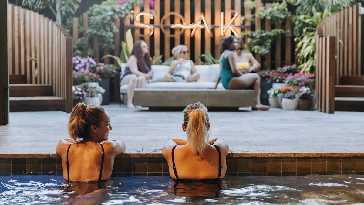 Connect with friends in the warm mineral pools at Soak Bathhouse Mermaid Beach