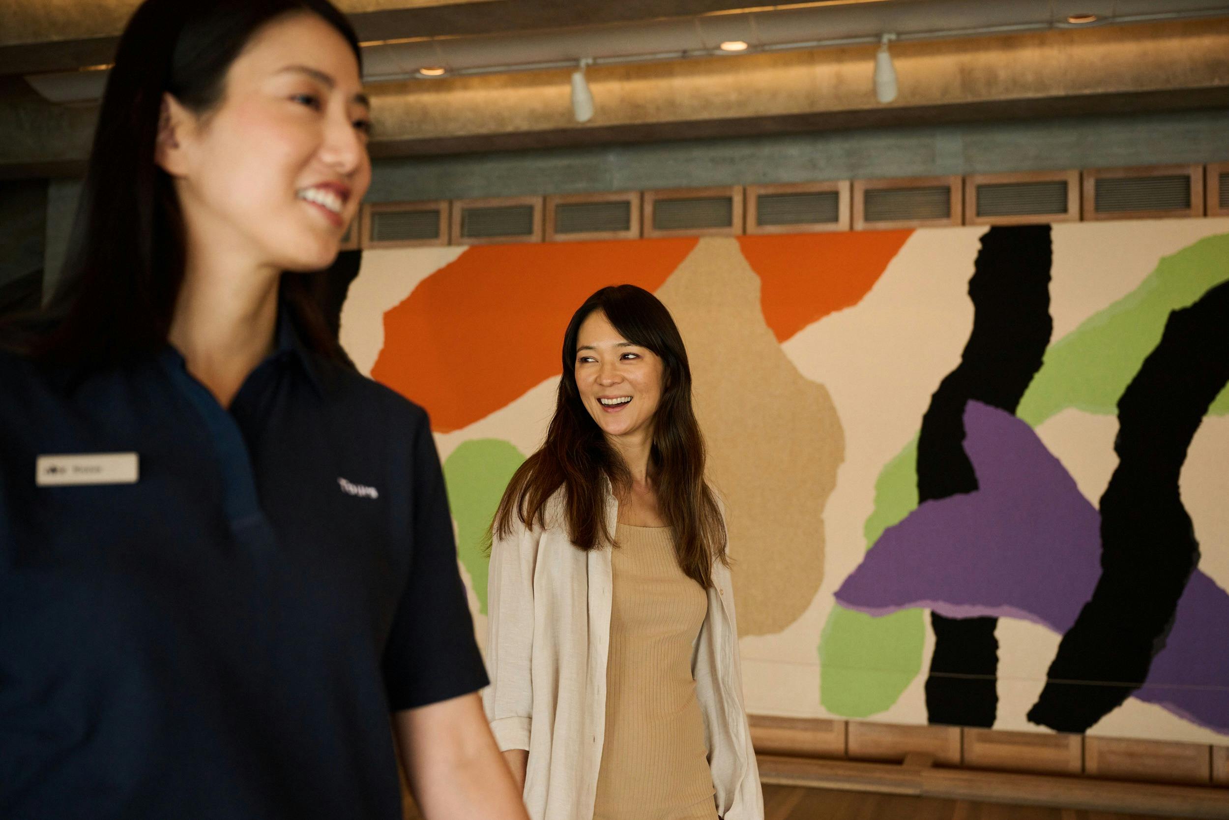 Tour guide and woman walking through the Utzon Room