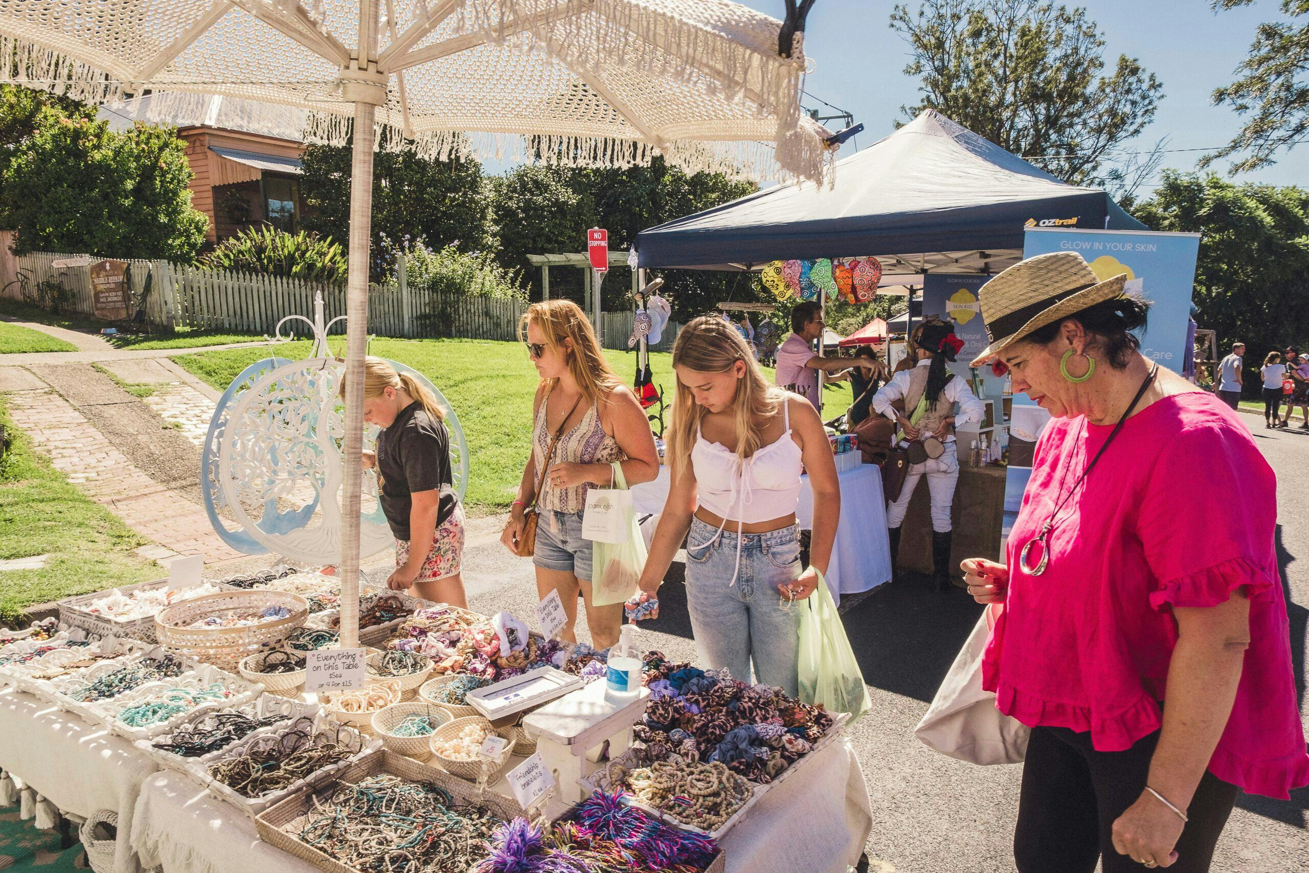 festival goers peruse a market stall at the Tilba Festival