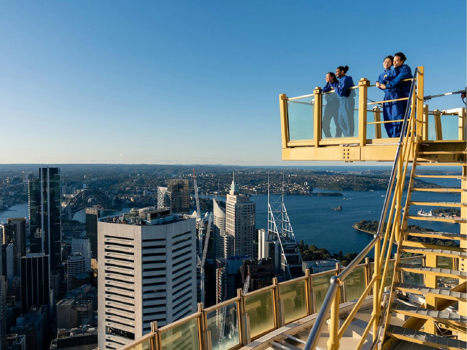Guests on the glass platform at SKYWALK overlooking Sydney Harbour