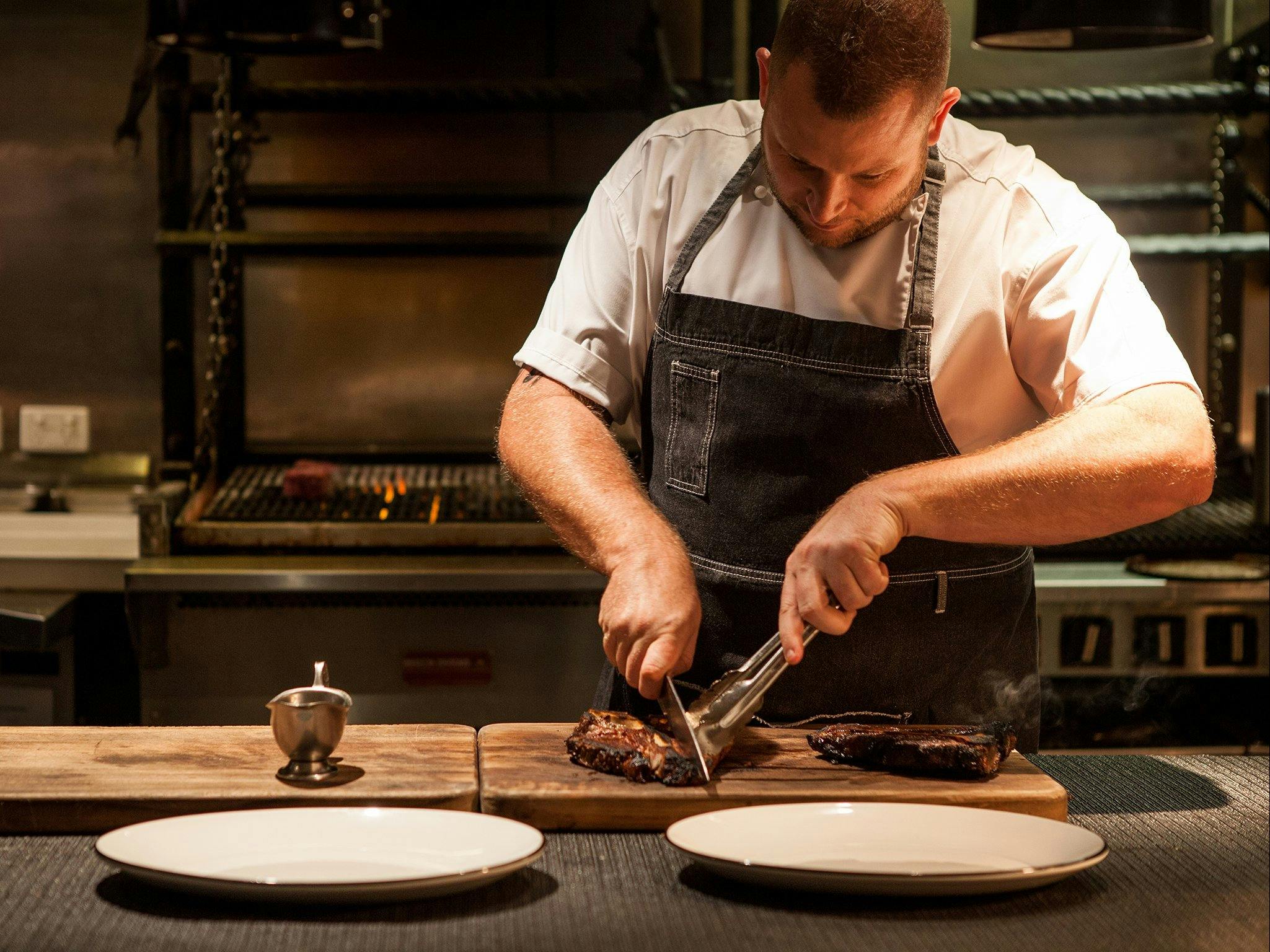 Chef cutting steaks