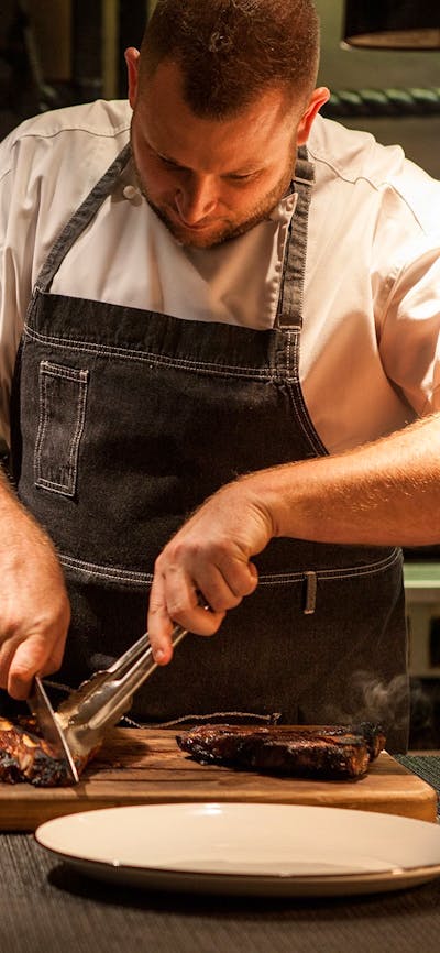 Chef cutting steaks