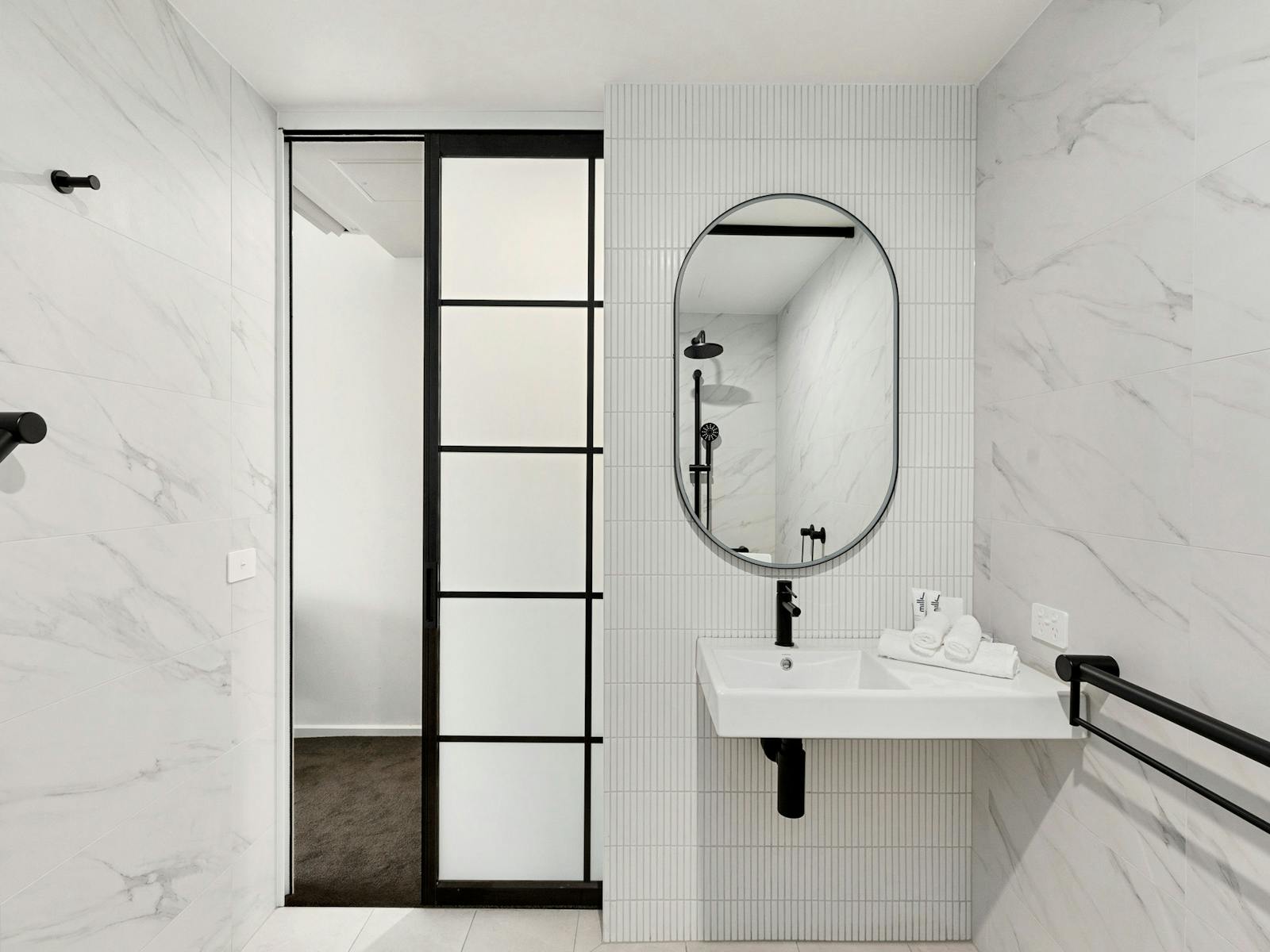 Detail shot of bathroom vanity and sliding door from bedroom