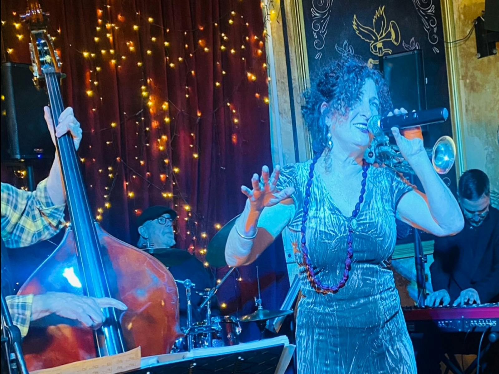live with part double bass drums in back keys to side and front female singer