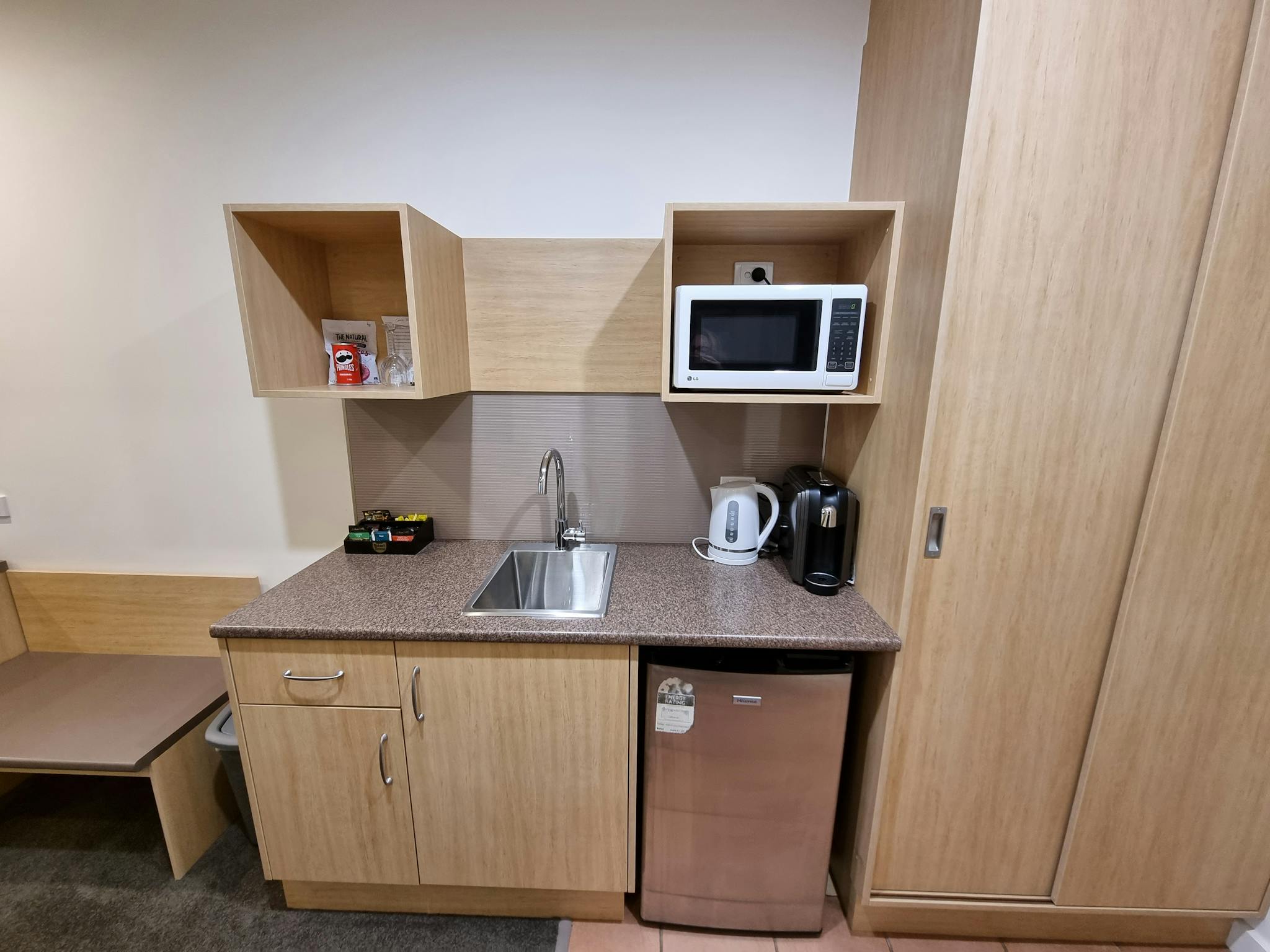 Kitchen comprises of coffee pod machine, toaster, kettle, microwave, mini bar, crockery & cutlery