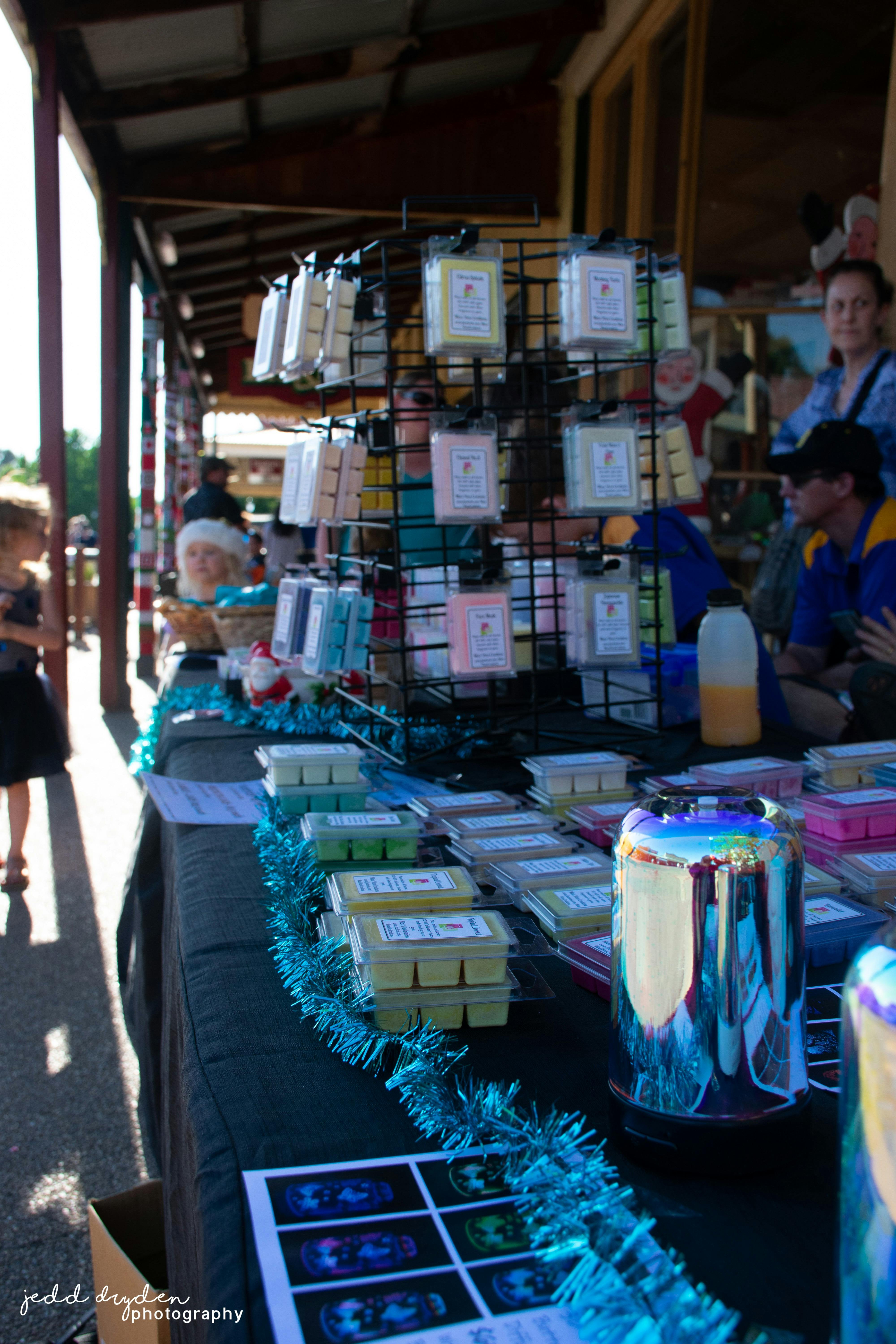 Candles and wax melts fill the table for sale