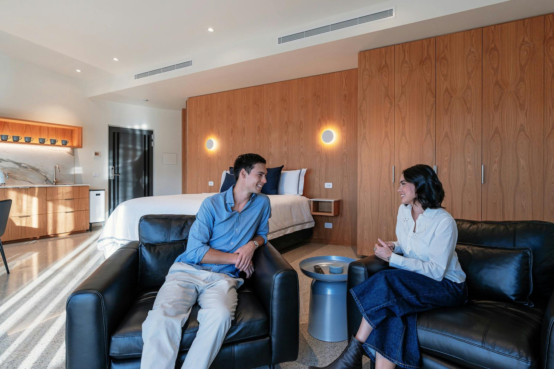 Couple sitting on chairs at Retreat Studio at Chrismont