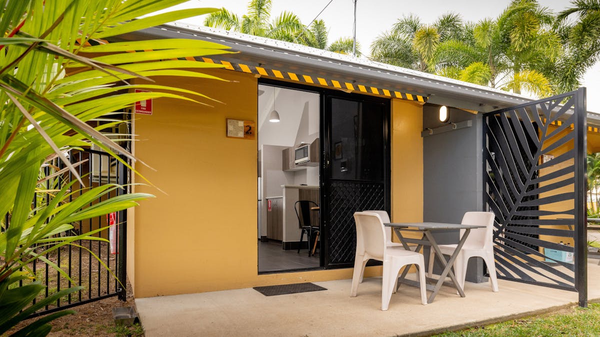 Queen Villa with table and chairs on neat, private patio.