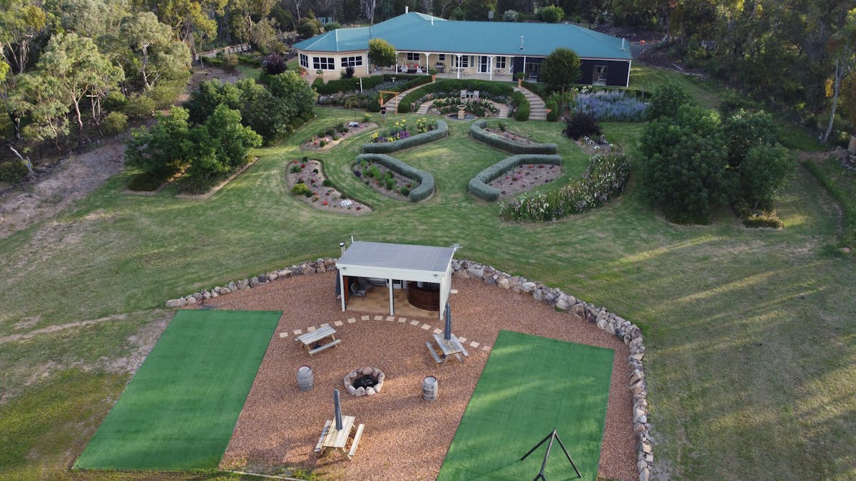 Outdoor Kitchen, fire pit badminton courts with suites in the background