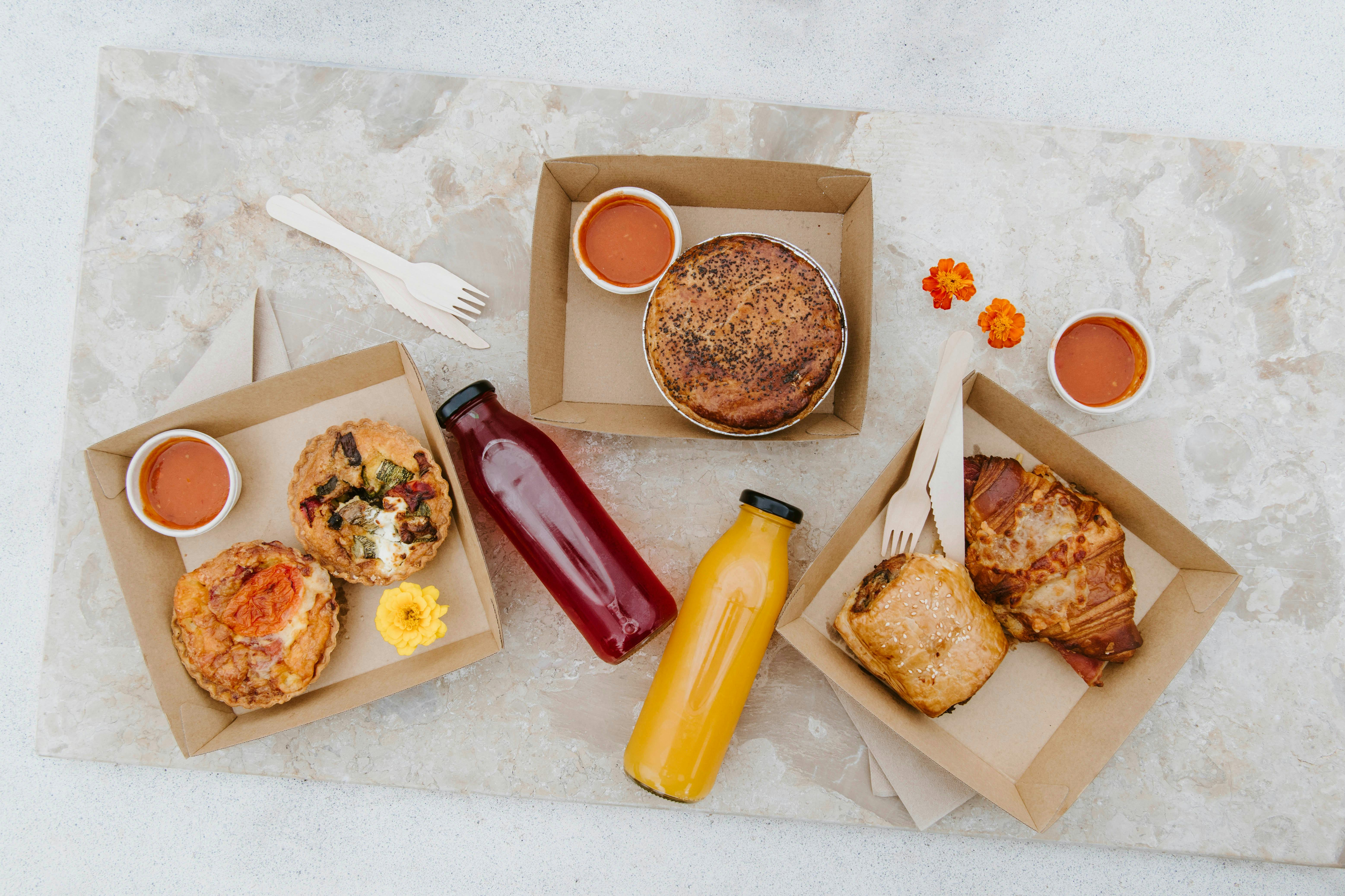 A selection of savory pastry and fresh juice options available at Althea by Zin