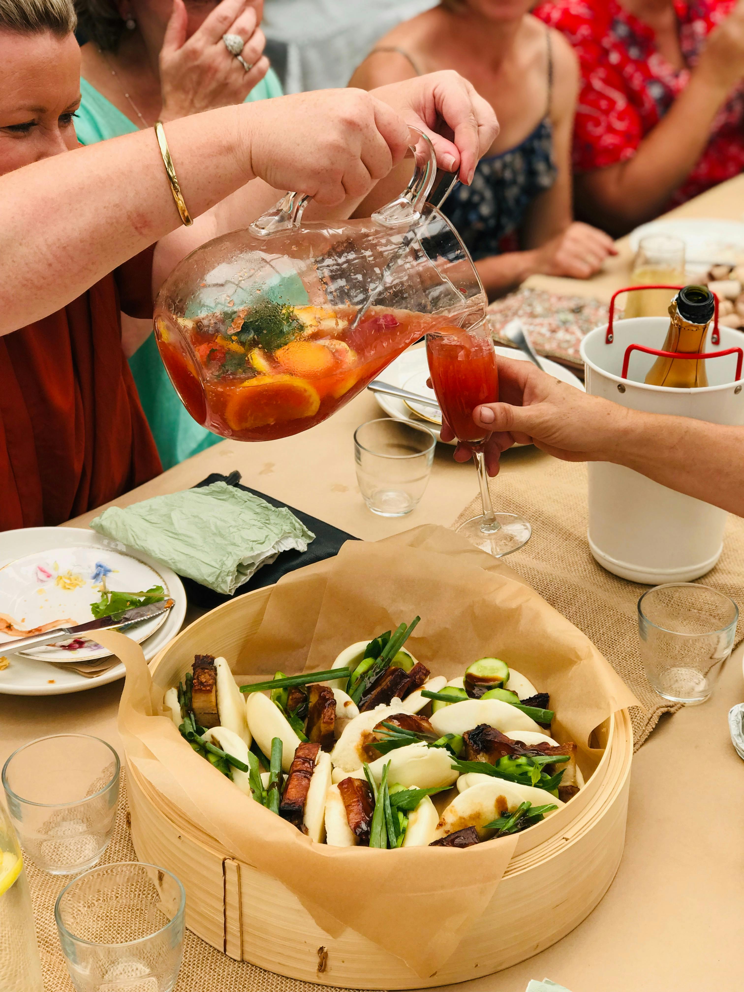 Ladies enjoying punch, bubbles and pork belly buns