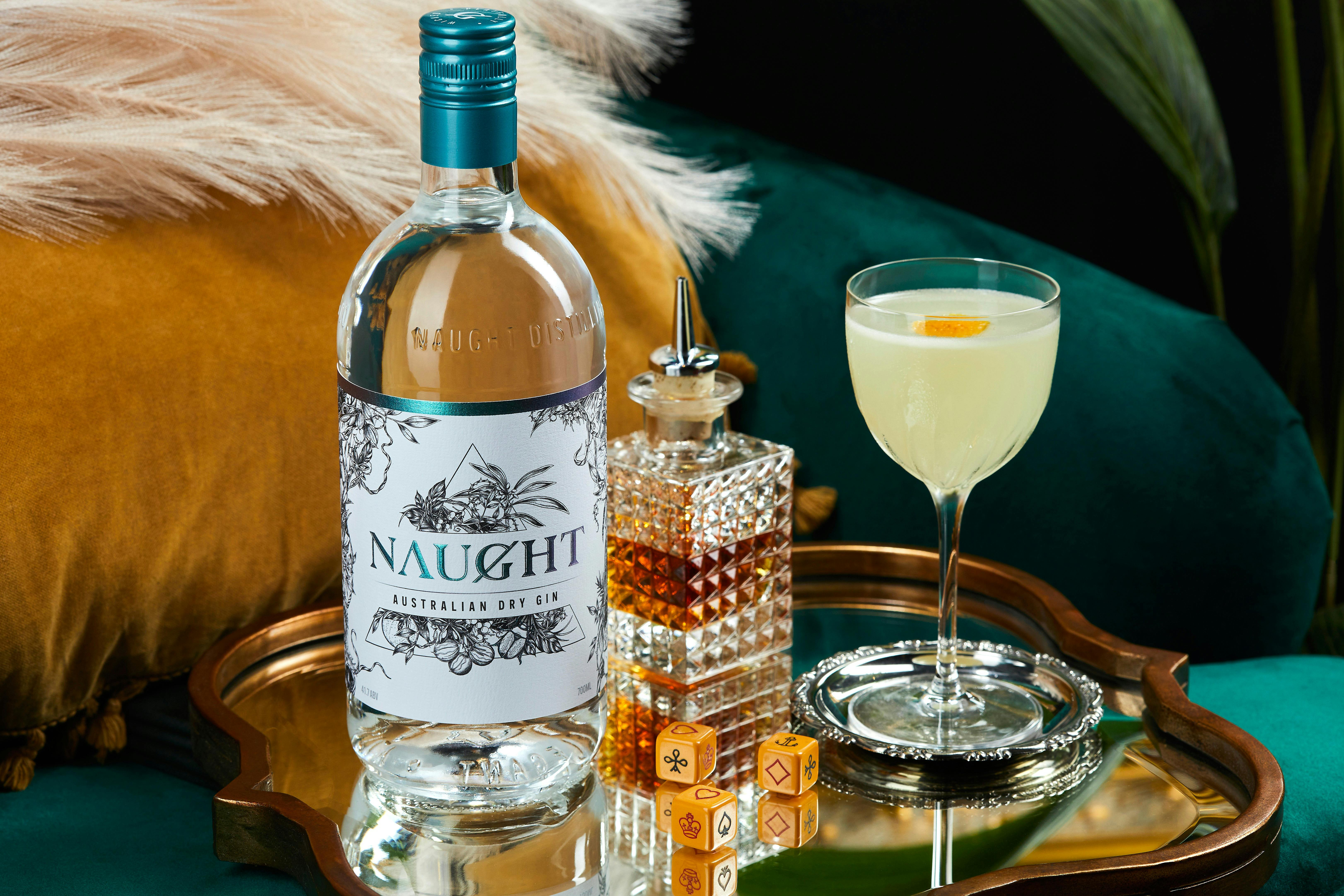 A Naught gin bottle with a lemon cocktail on a tray