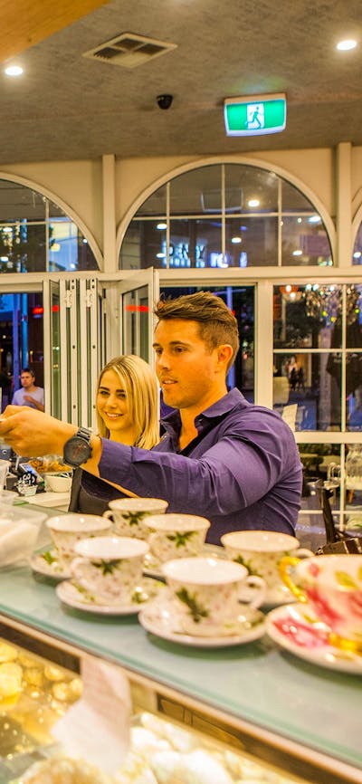 Couple couple being served cake over the counter