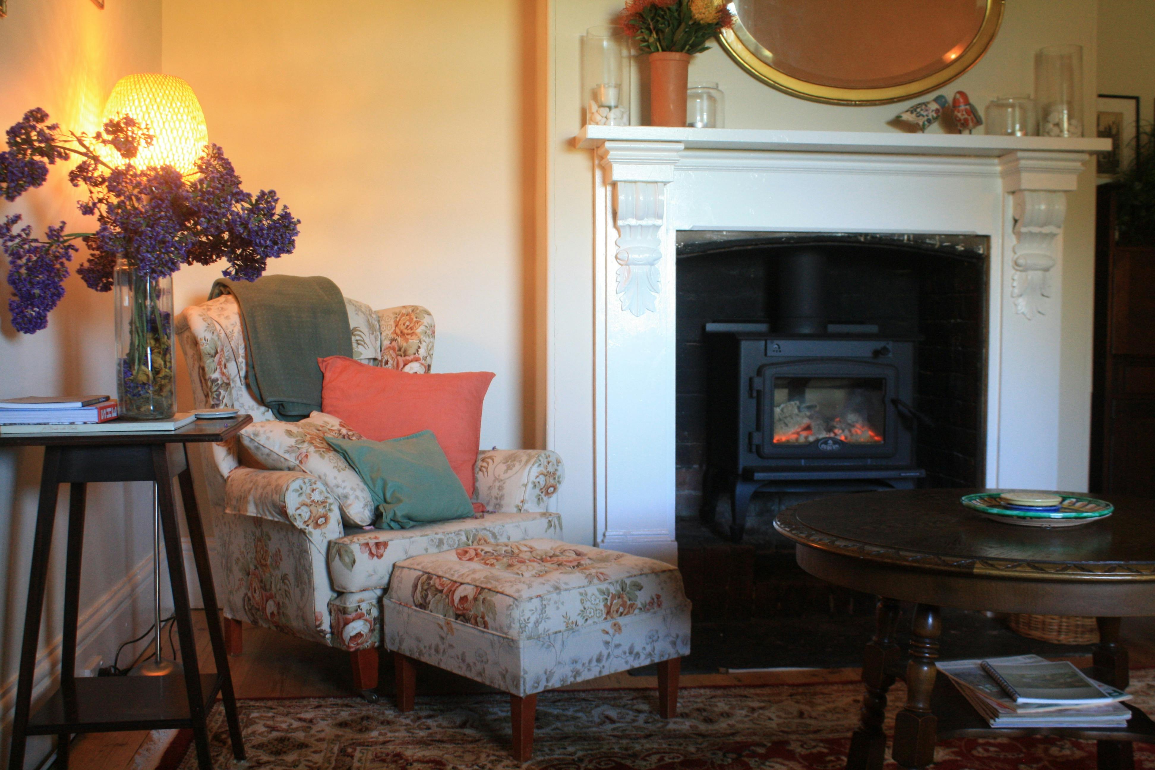 Sitting room. A warm fire, cuppa, fireside books, games and your own music through Bose speaker...