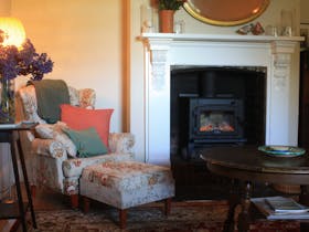 Sitting room. A warm fire, cuppa, fireside books, games and your own music through Bose speaker...