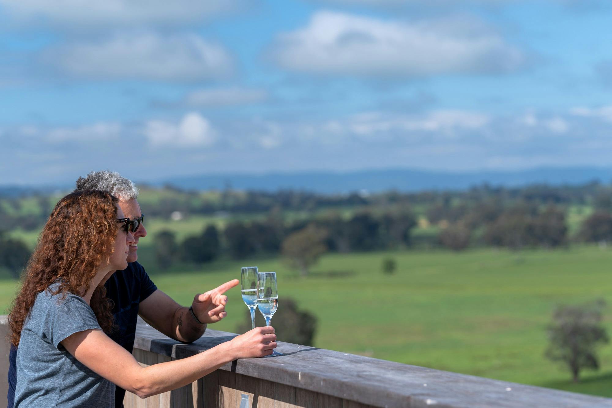 Couple enjoying the beautiful countryside views  from the rooftop at BullerRoo Luxury Farmstay