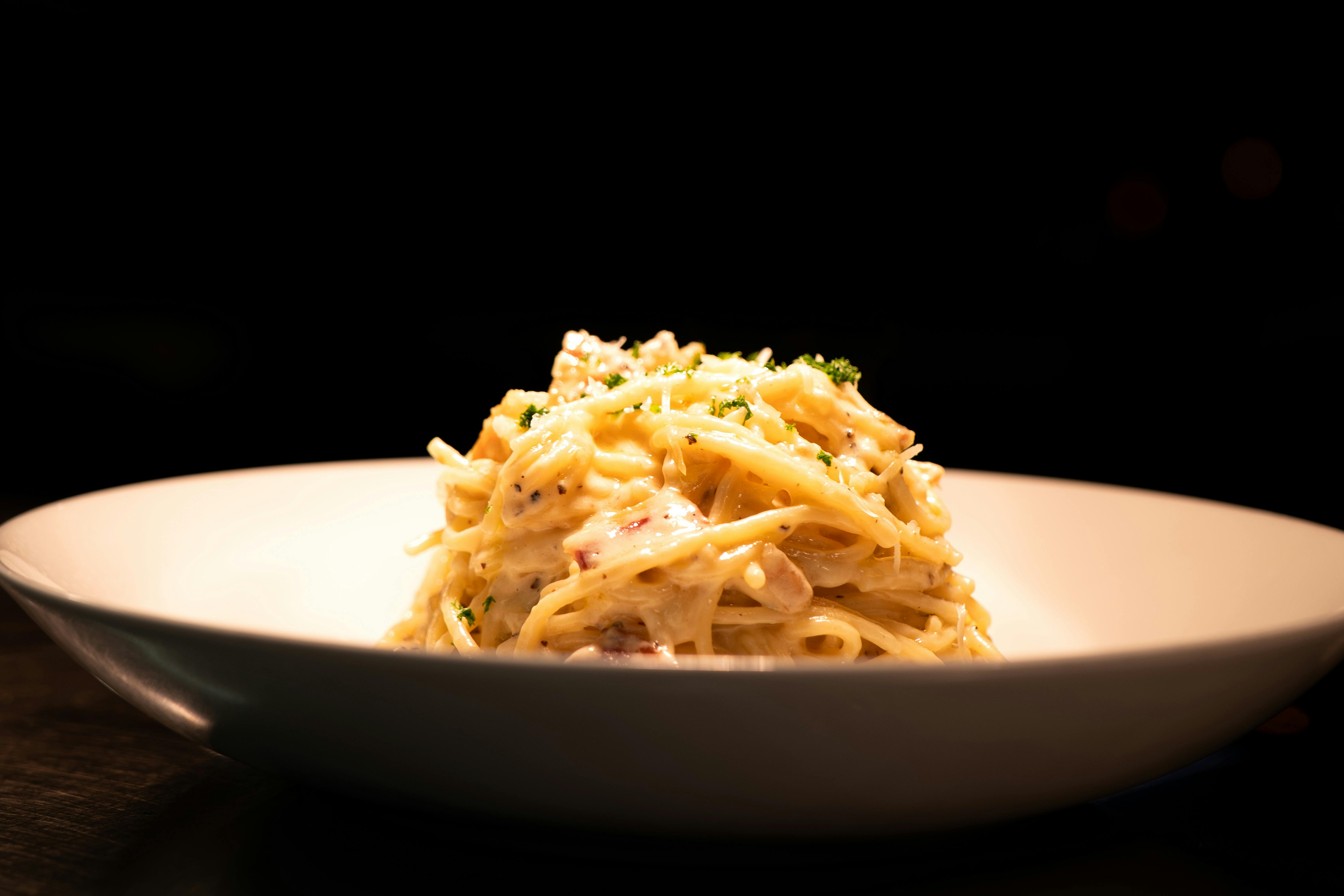 A warm bowl of spaghetti under the pass lights, ready for the table.