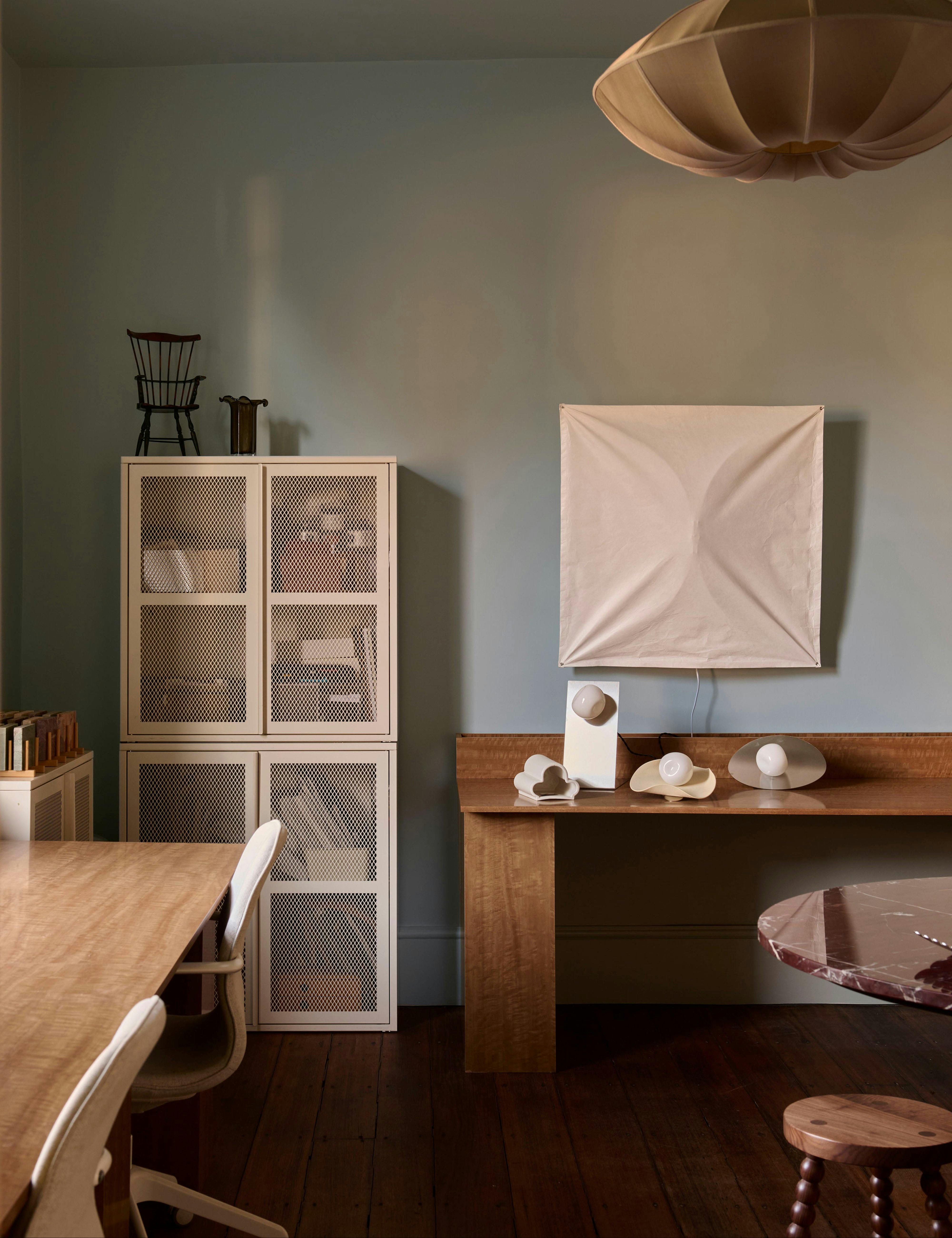 Ceramic and glass lights displayed on a timber table in We Ponder's South Hobart studio.