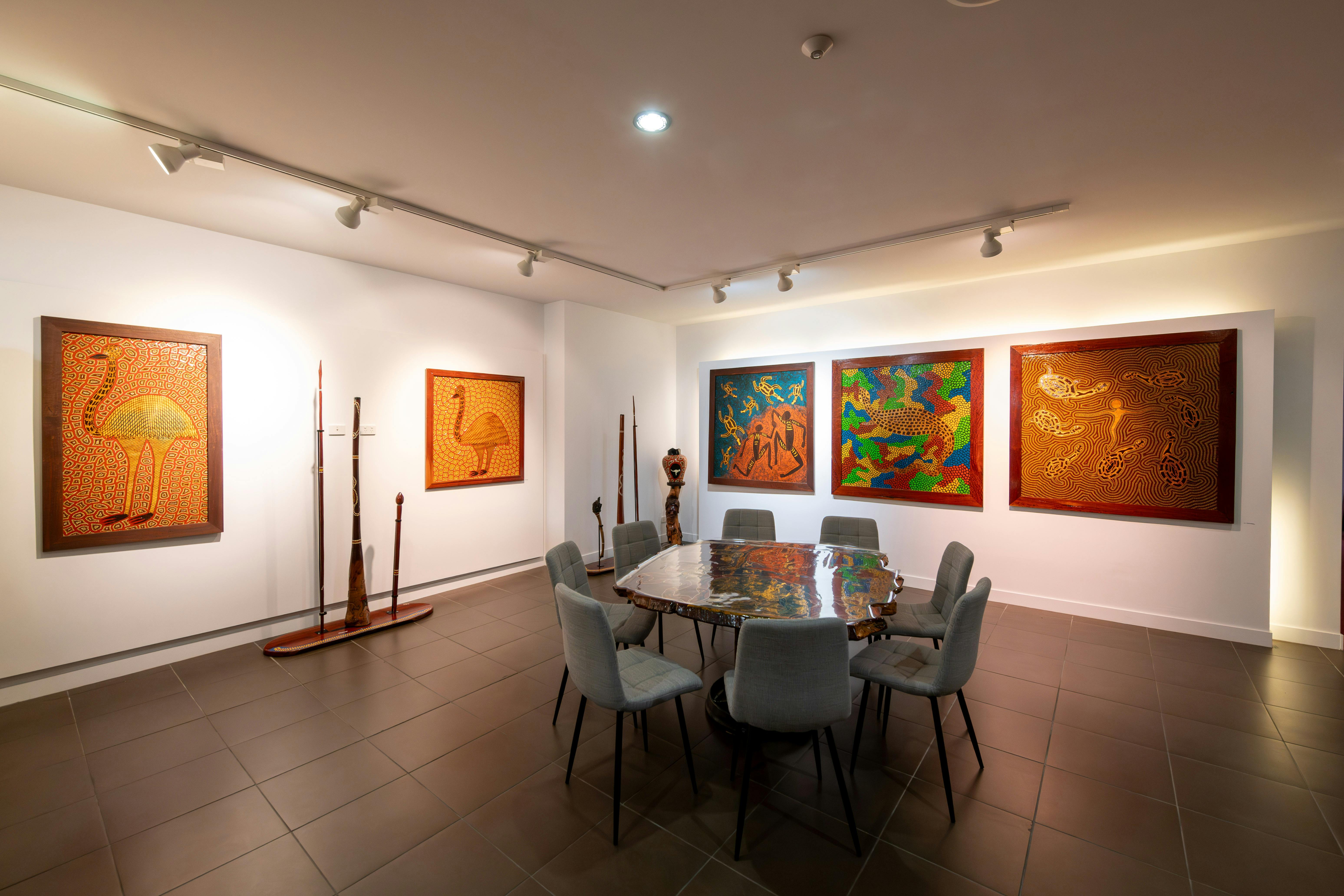 wide angle view of the DUMAWUL gallery space with colourful paintings on the walls