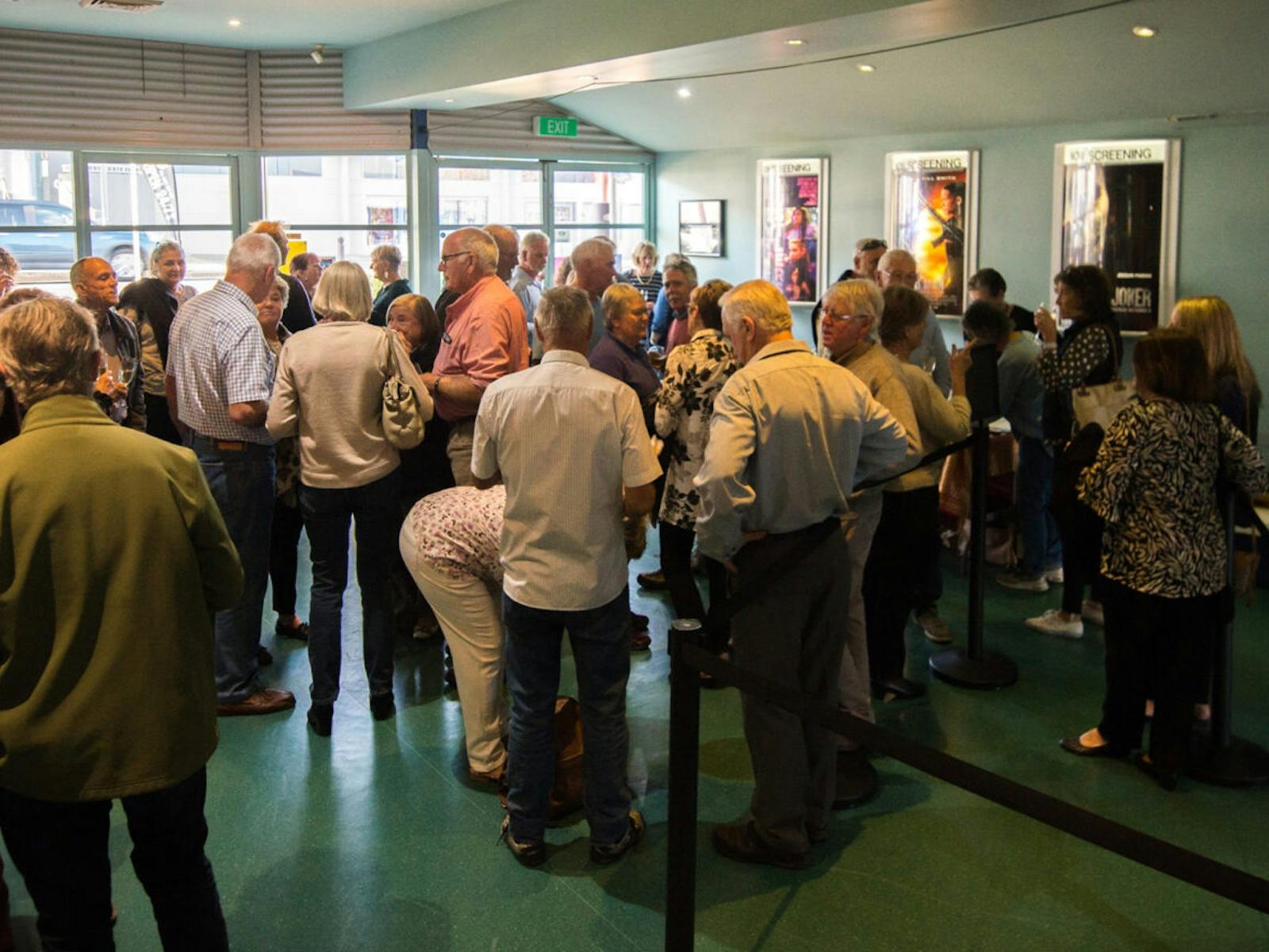 People gather in the cinema foyer